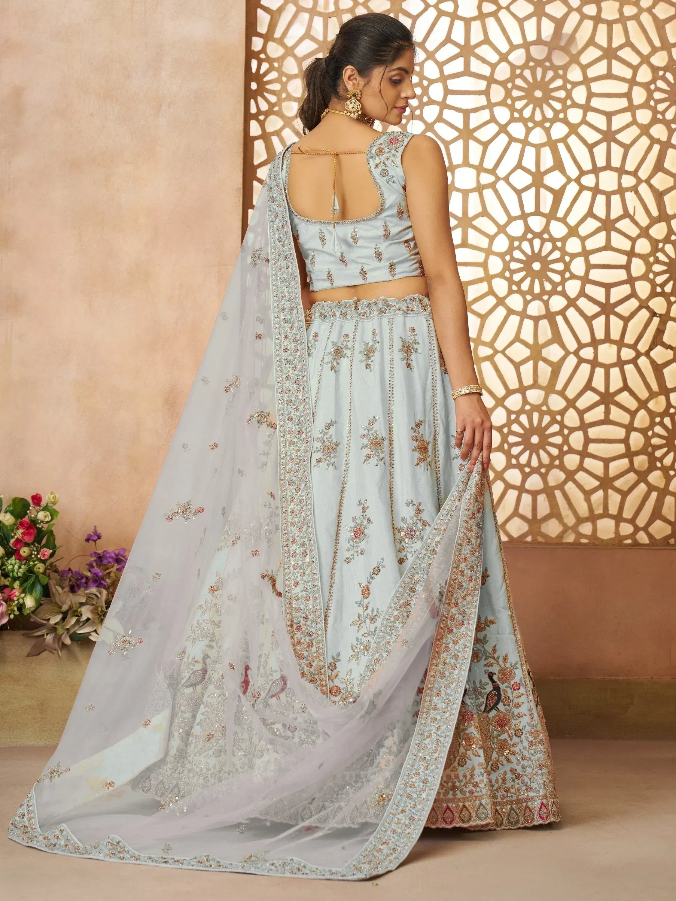 Light blue embroidered lehenga choli with peacock motifs and sheer dupatta, perfect for Indian ethnic occasions.