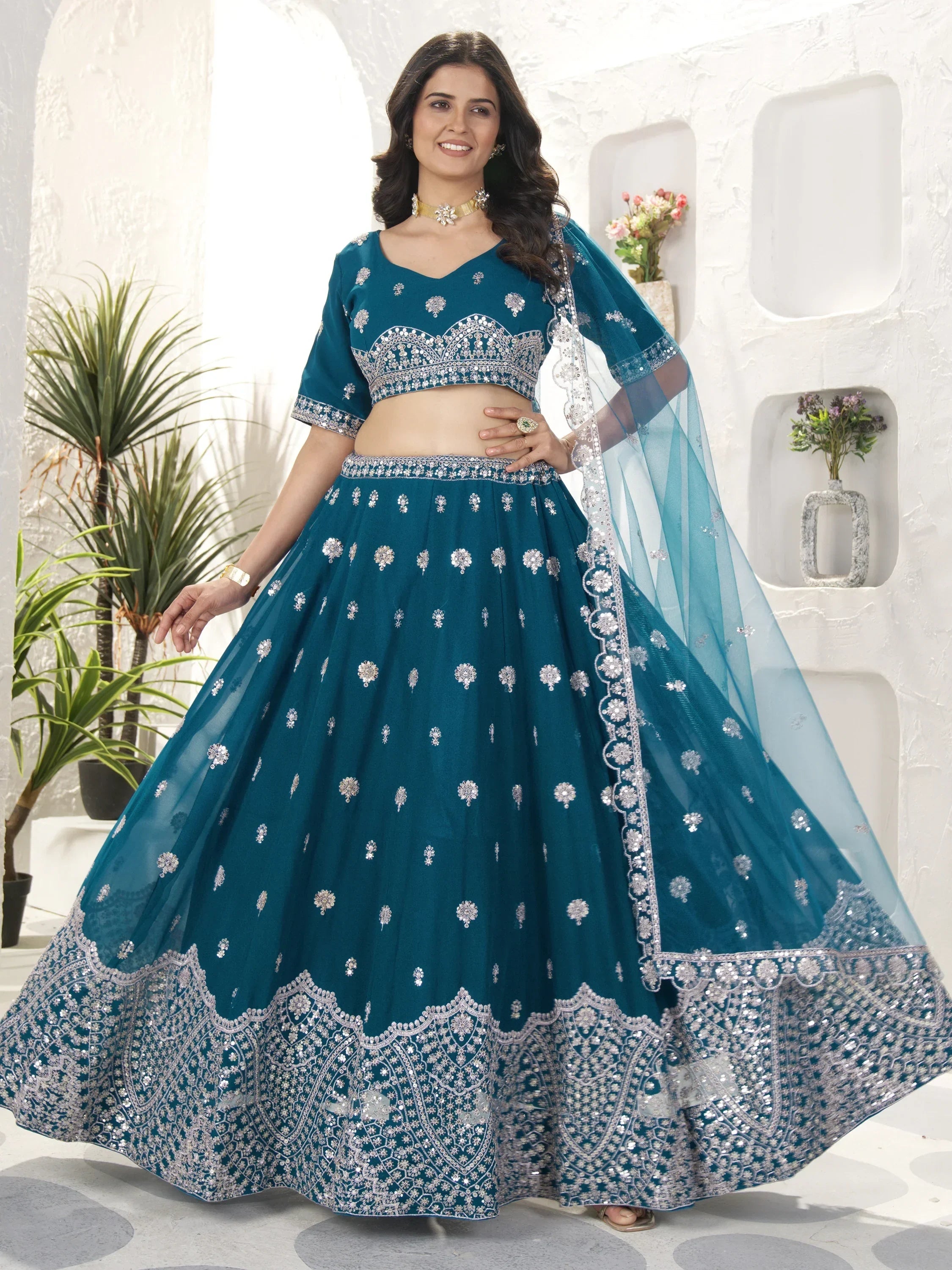 Teal blue designer lehenga choli with silver embroidery, perfect for Indian ethnic wear and festive occasions.