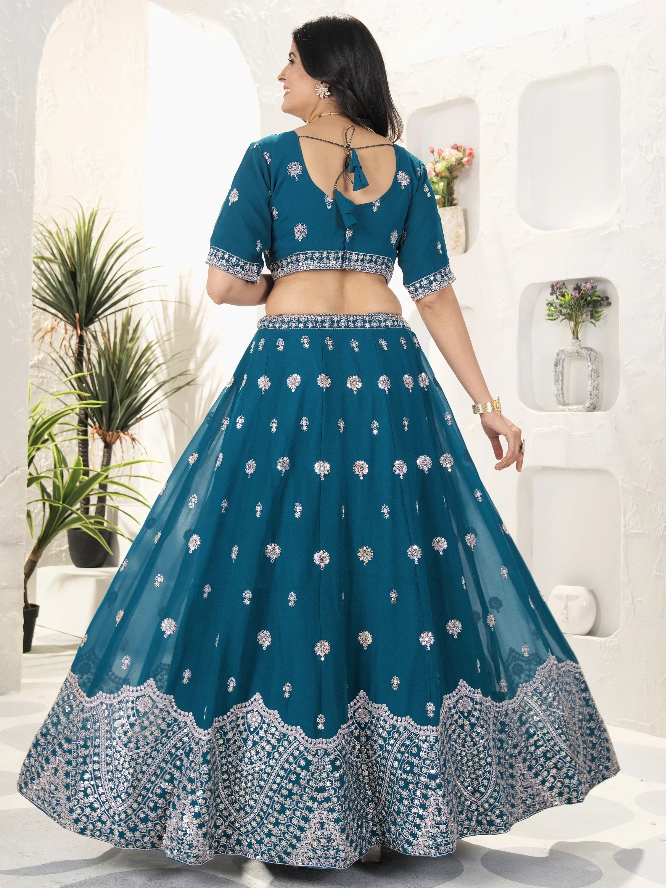 Teal designer lehenga choli with silver embroidery, back view, ethnic wear for women