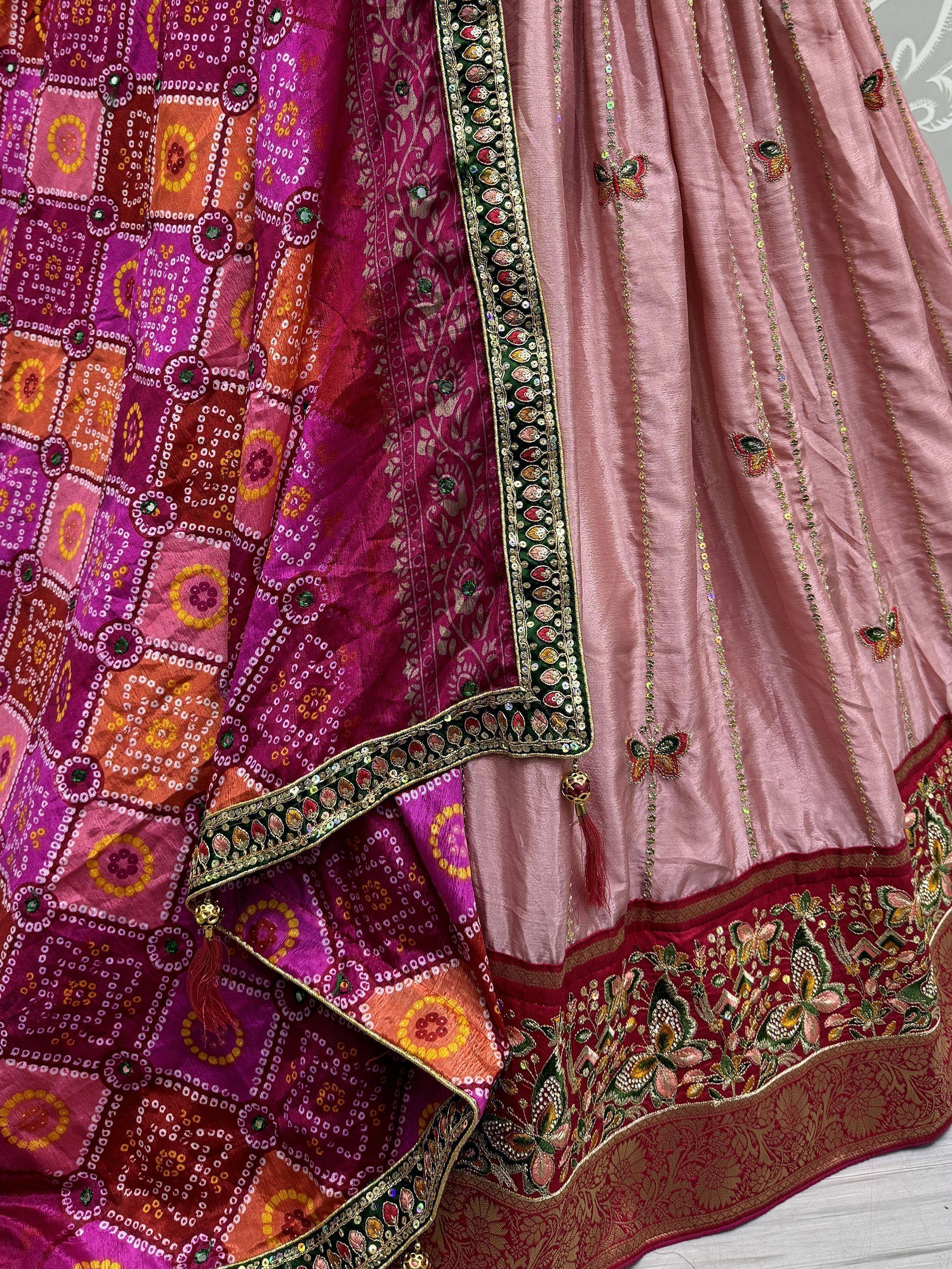 Pink and purple designer lehenga choli with intricate embroidery, mirror work, and butterfly motifs for Indian ethnic wear