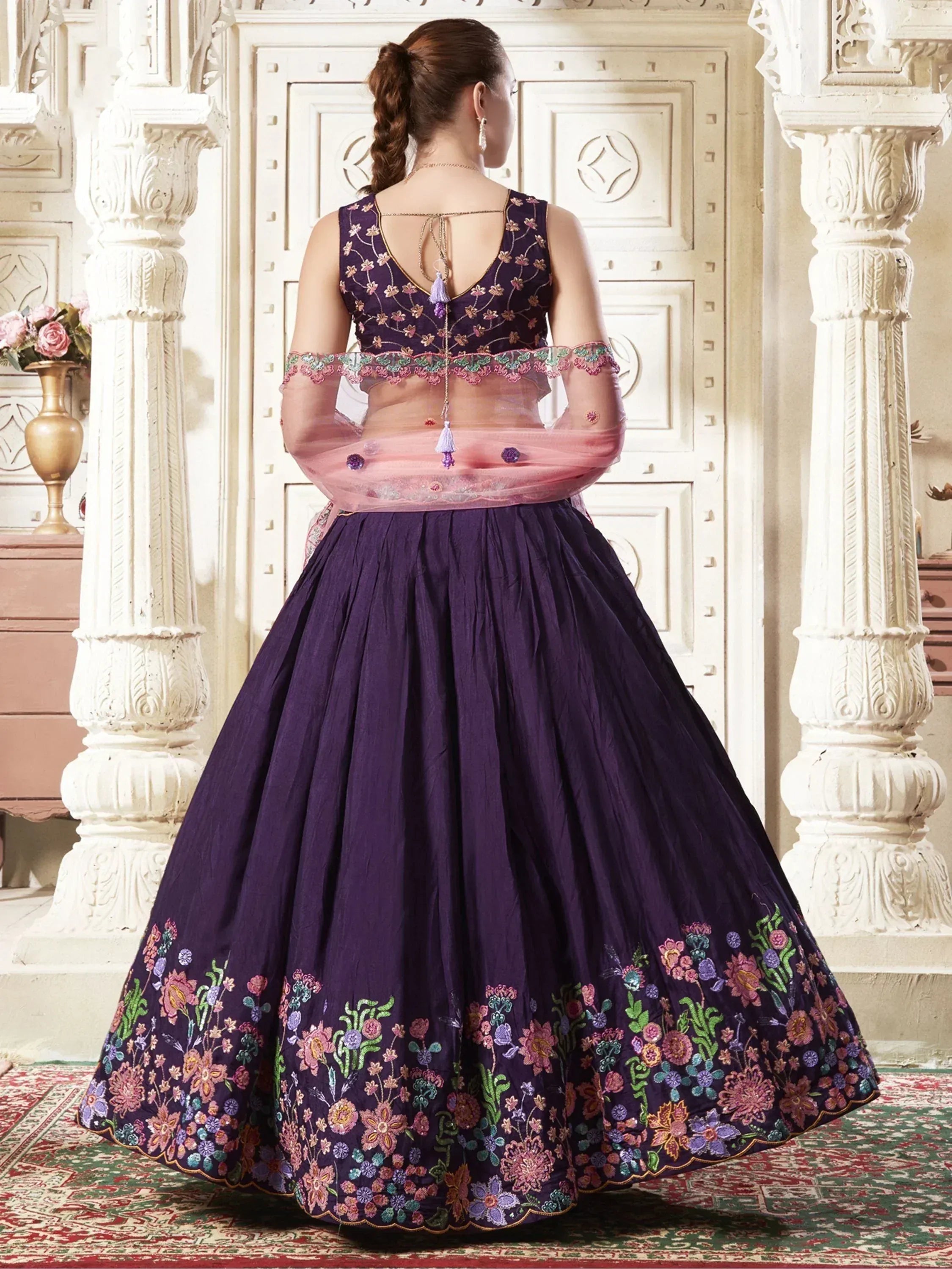 Purple embroidered lehenga choli with floral detailing and sheer pink dupatta, ideal for Indian ethnic occasions