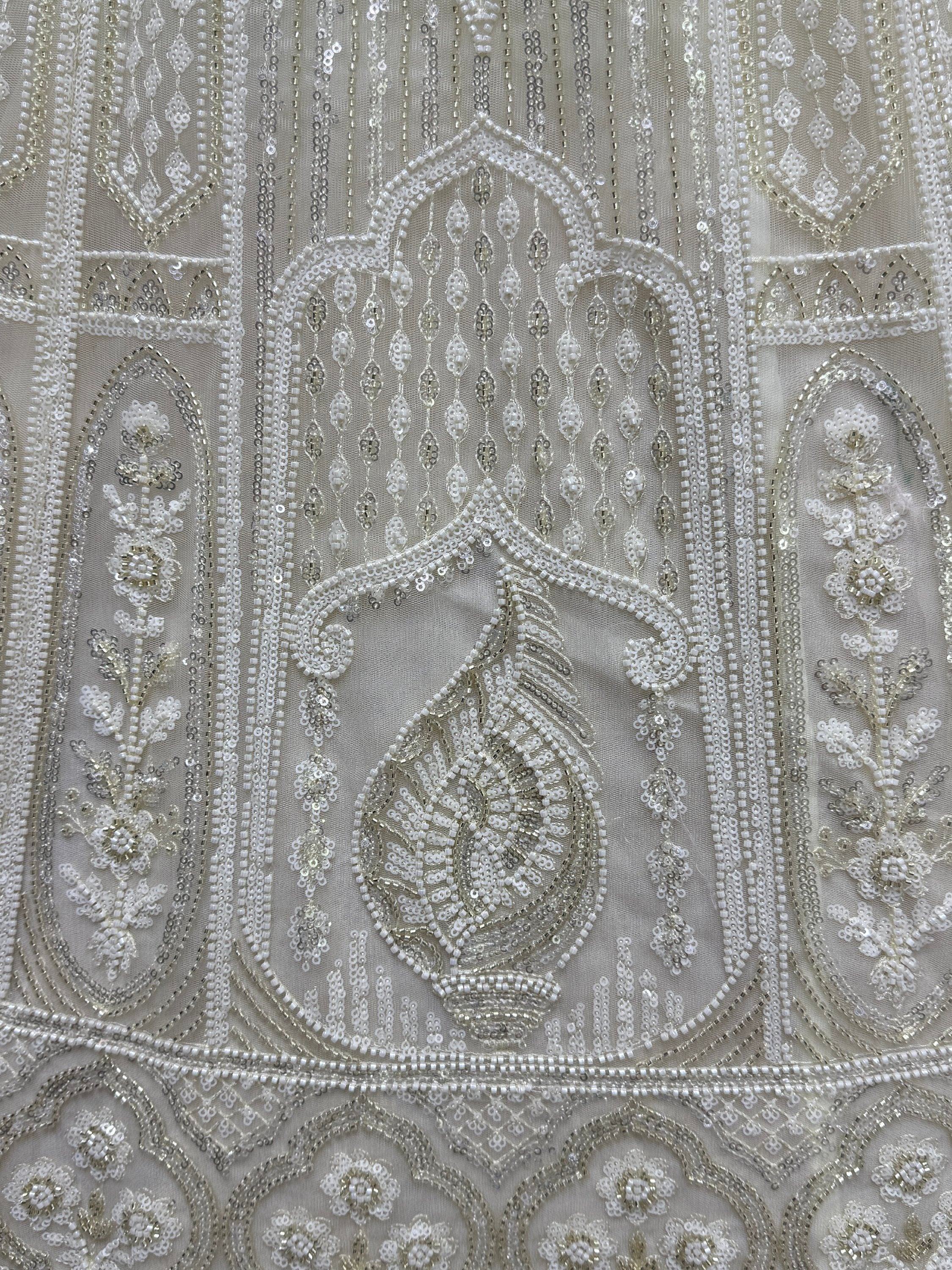 Elegant ivory ethnic wear with intricate beadwork and sequin embroidery for weddings and festivals
