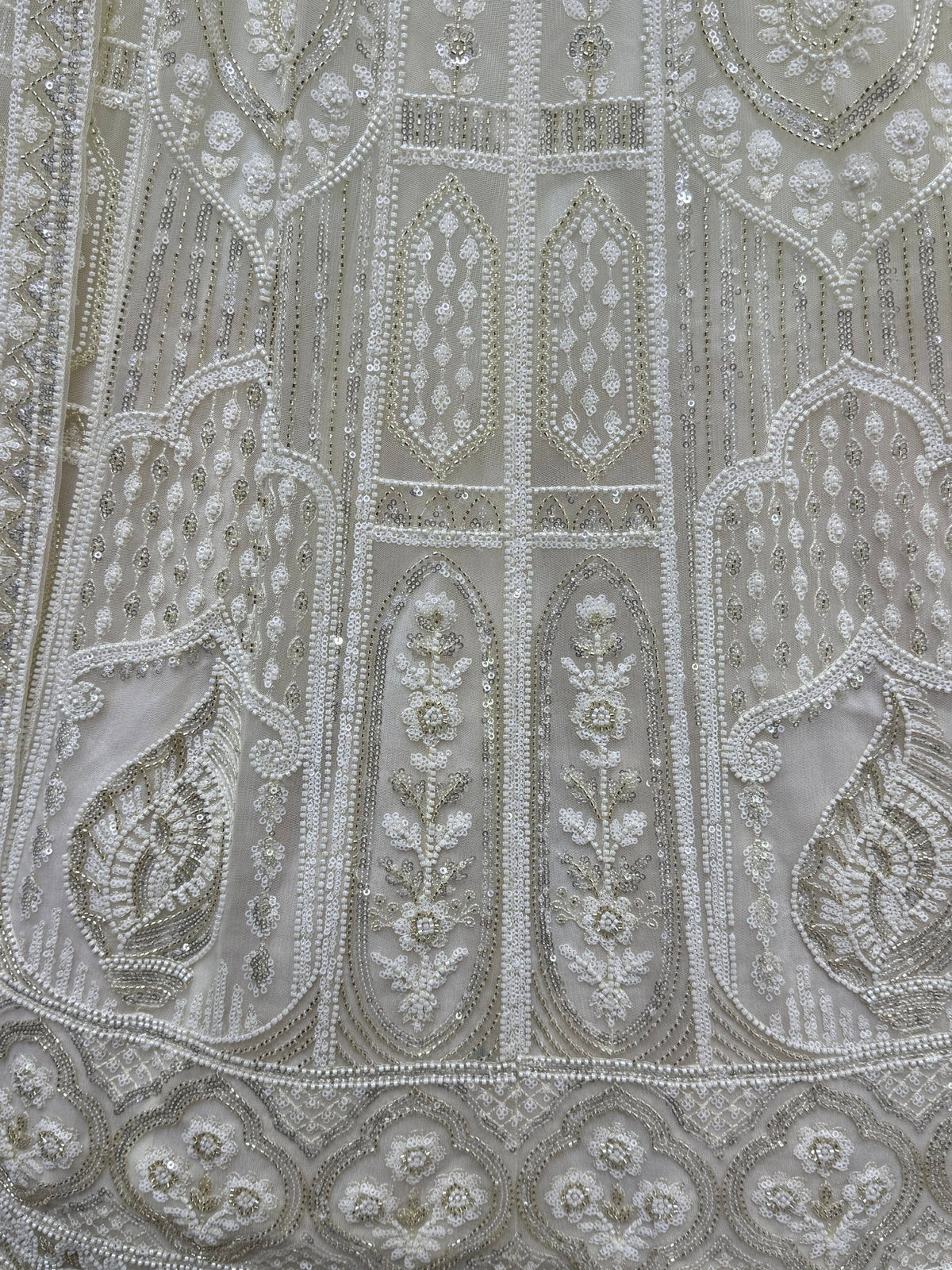 Exquisite white ethnic wear with intricate beadwork and sequin embroidery, perfect for Indian weddings and festive occasions.