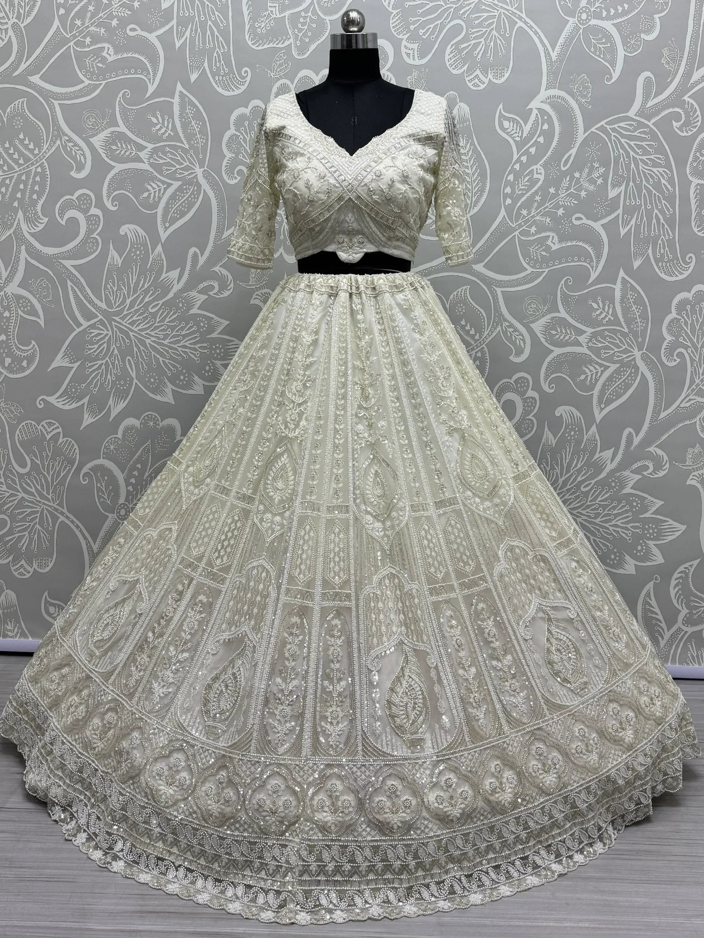 Ivory designer lehenga choli with heavy embroidery and beadwork, perfect for weddings and festivals