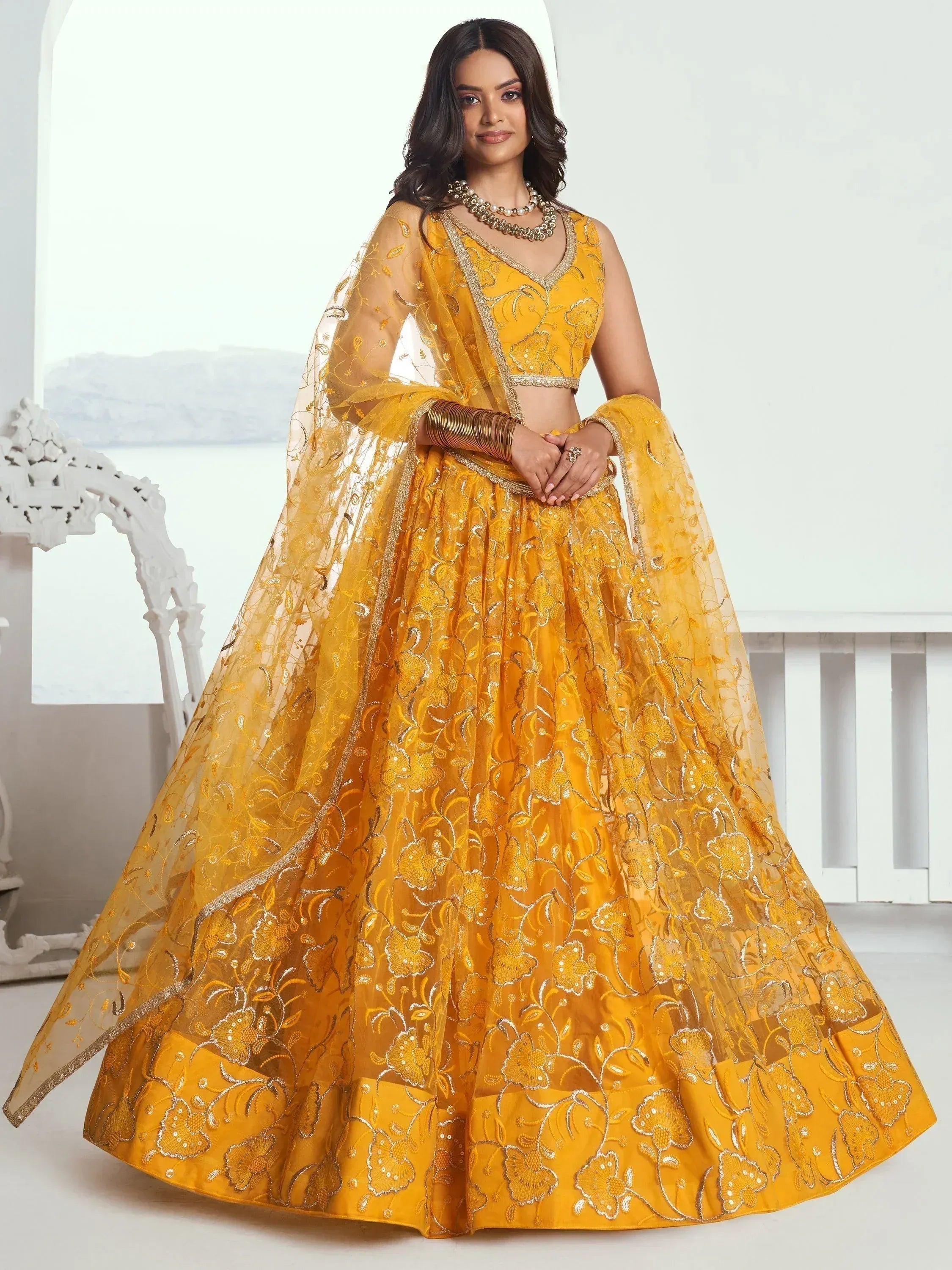 Yellow embroidered lehenga choli with floral design, perfect for Indian ethnic wear and festive occasions