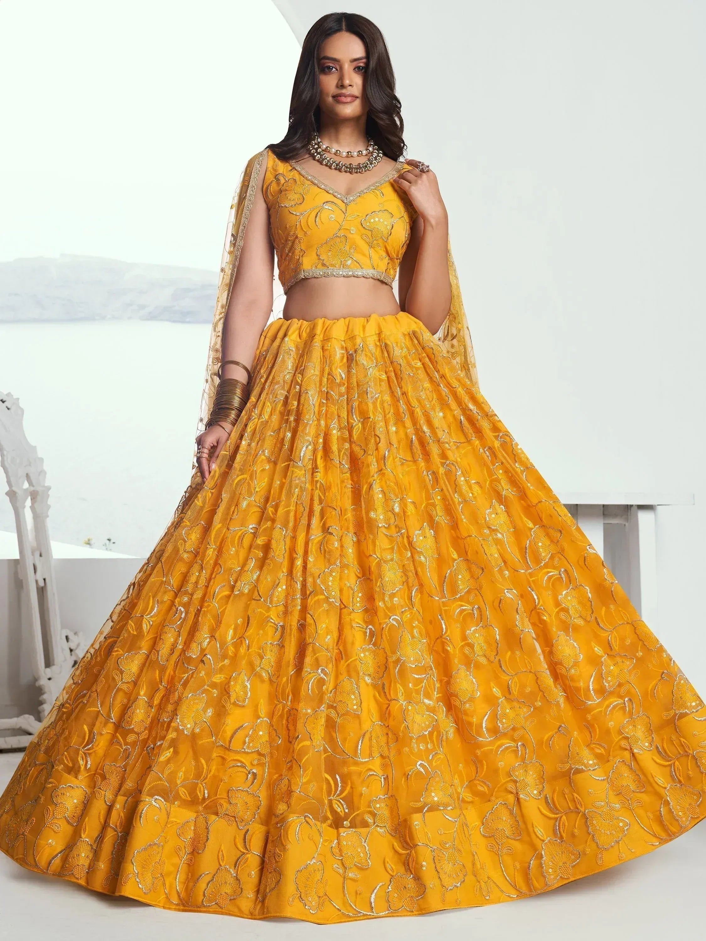 Yellow embroidered lehenga choli with floral design, perfect for Indian ethnic wear events