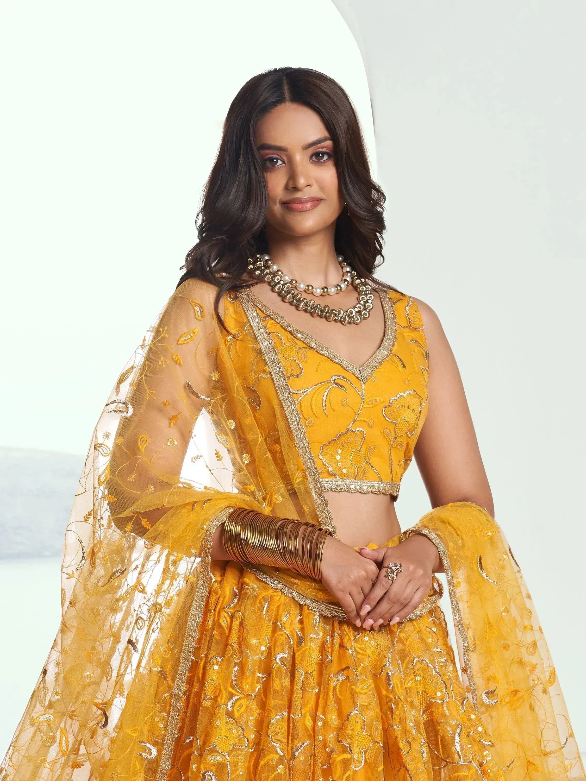 Pink floral lehenga with red rose print and gold embroidery border