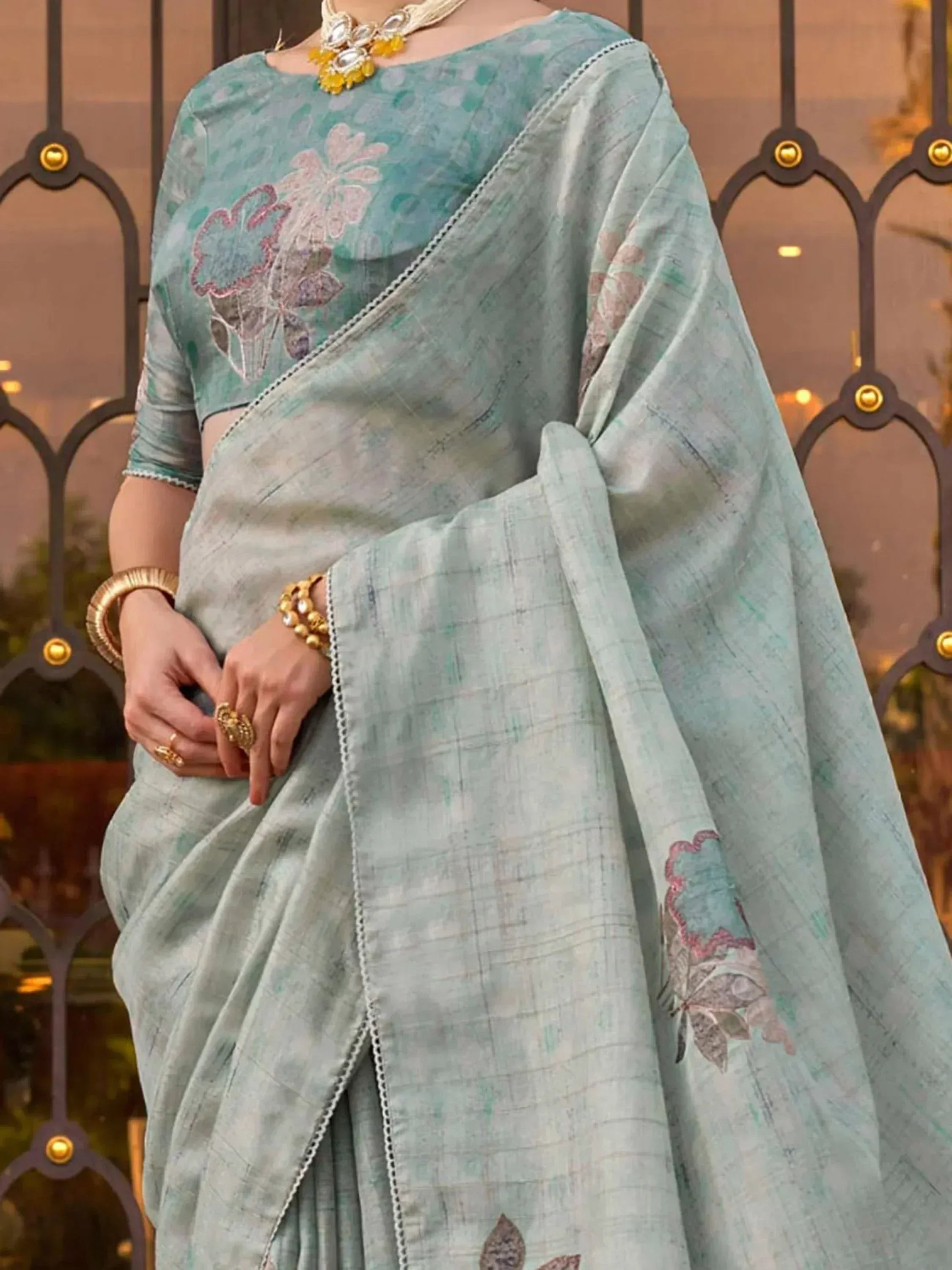 Mint green saree with floral embroidery and matching blouse, perfect for Indian ethnic wear occasions.