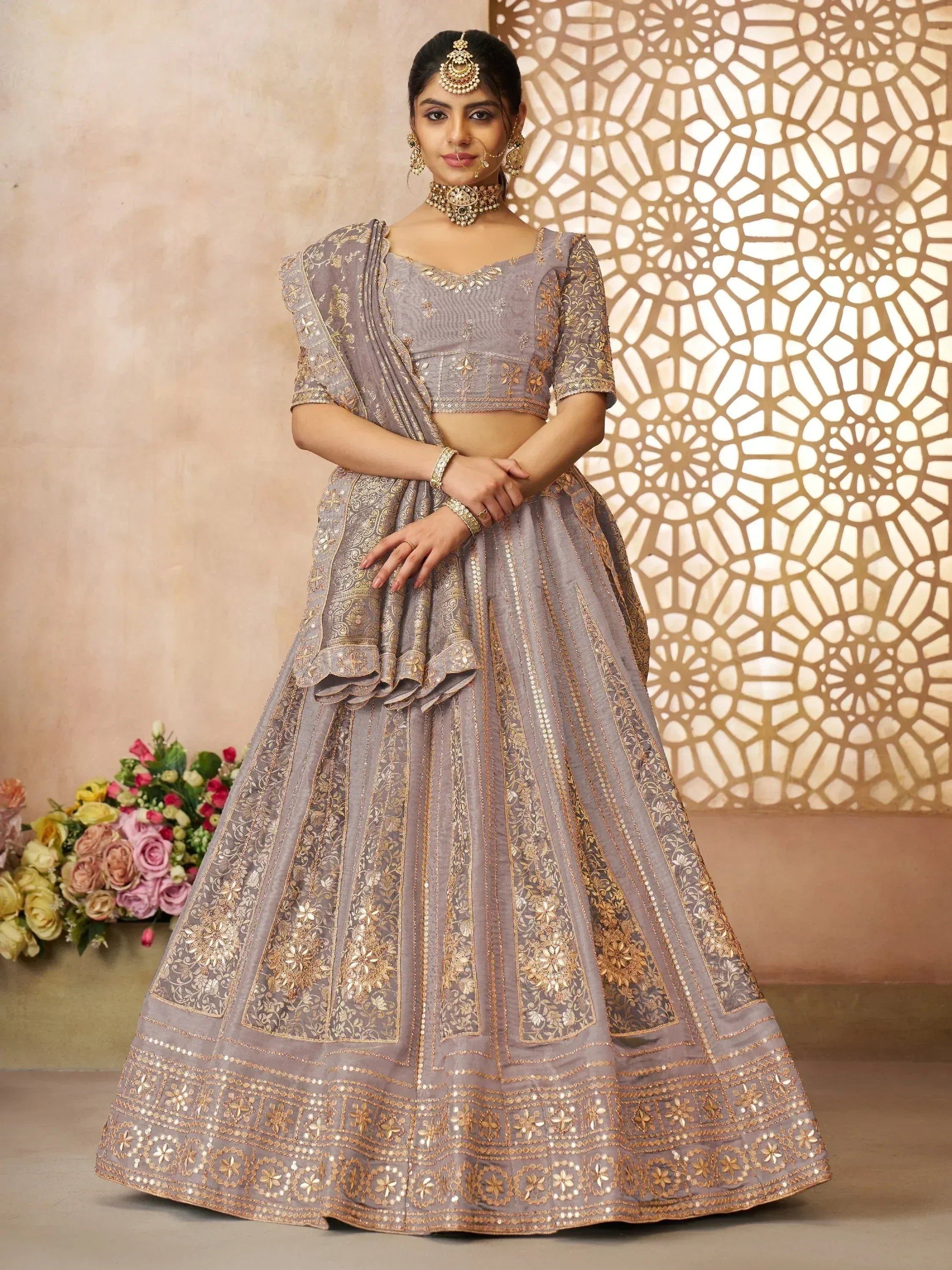 Grey designer lehenga choli with gold embroidery, perfect for Indian weddings and festive occasions.