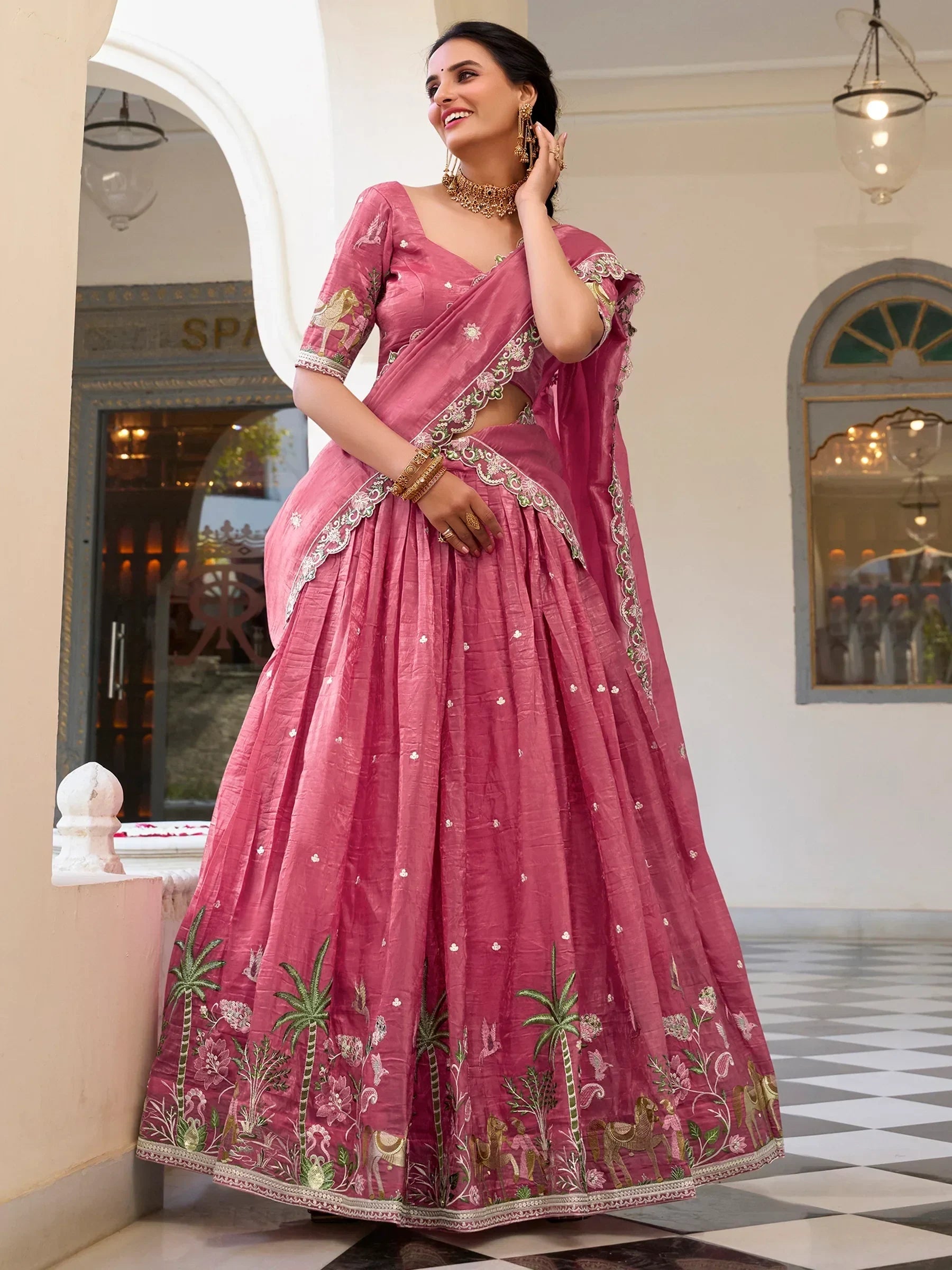 Pink embroidered lehenga choli with floral and horse motifs, perfect for Indian ethnic wear occasions.