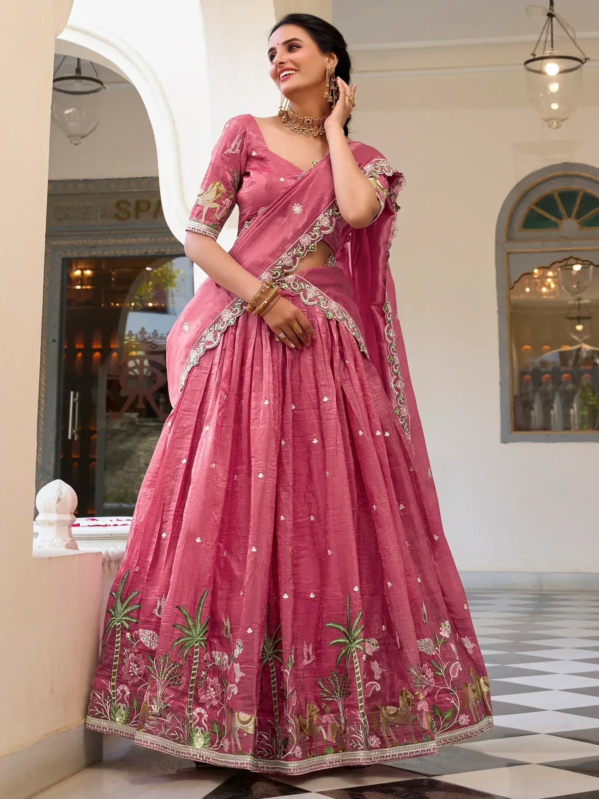 Pink embroidered lehenga choli with floral and horse motifs, perfect for Indian ethnic wear occasions.