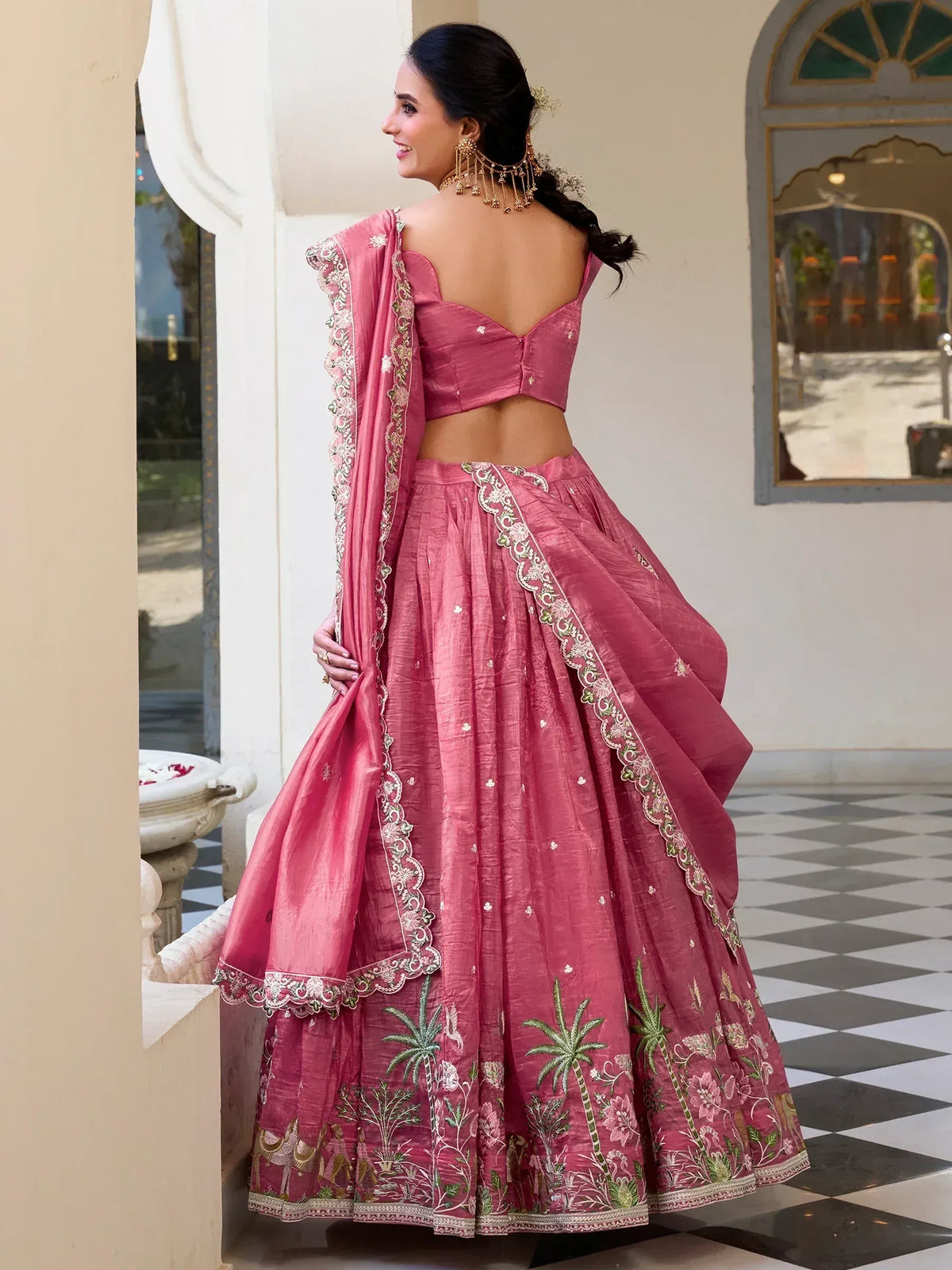 Pink embroidered lehenga choli with floral and palm tree motifs, perfect for Indian ethnic occasions