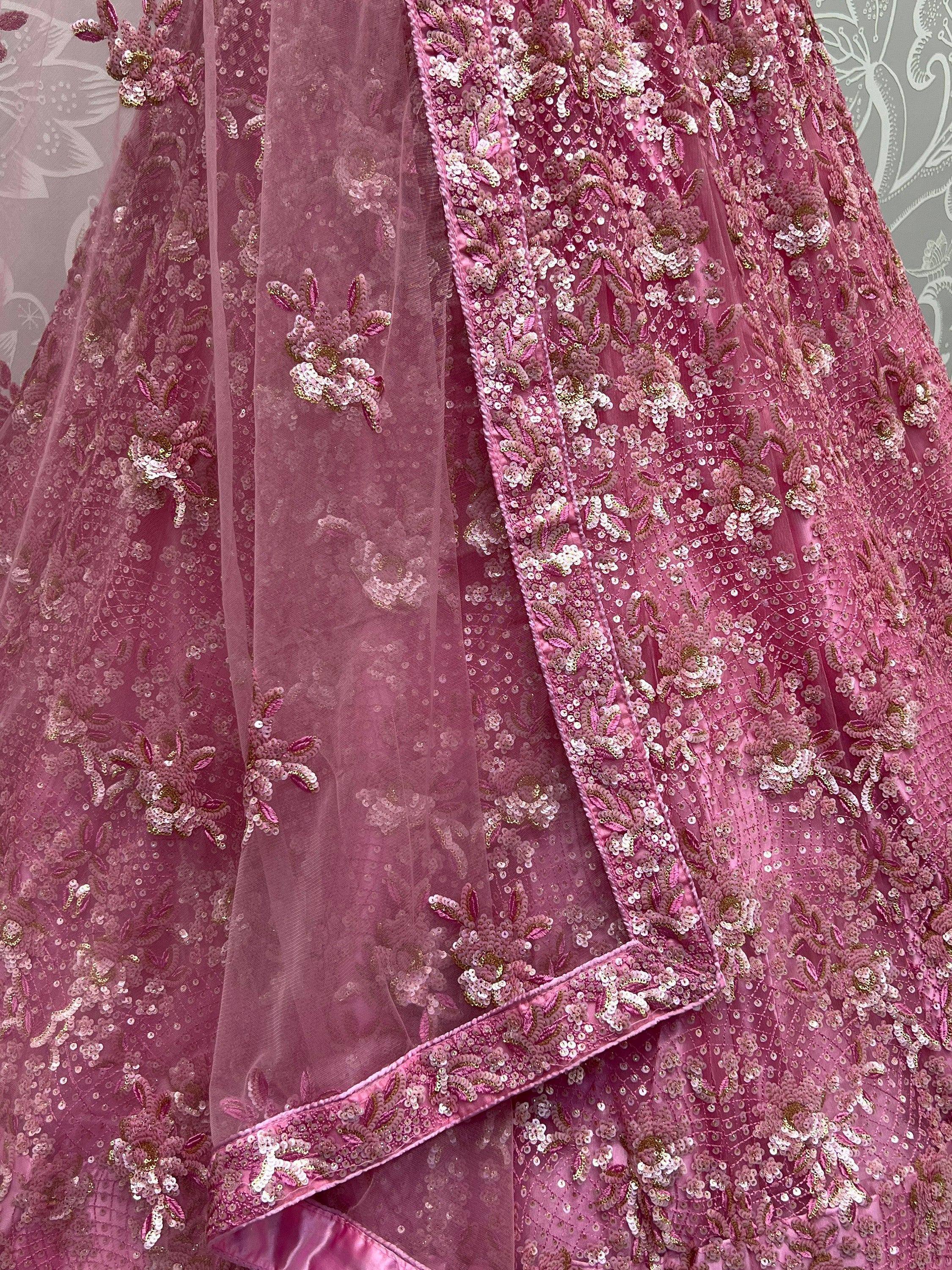 Pink sequin-embellished lehenga choli with floral embroidery and sheer dupatta, perfect for Indian ethnic wear.