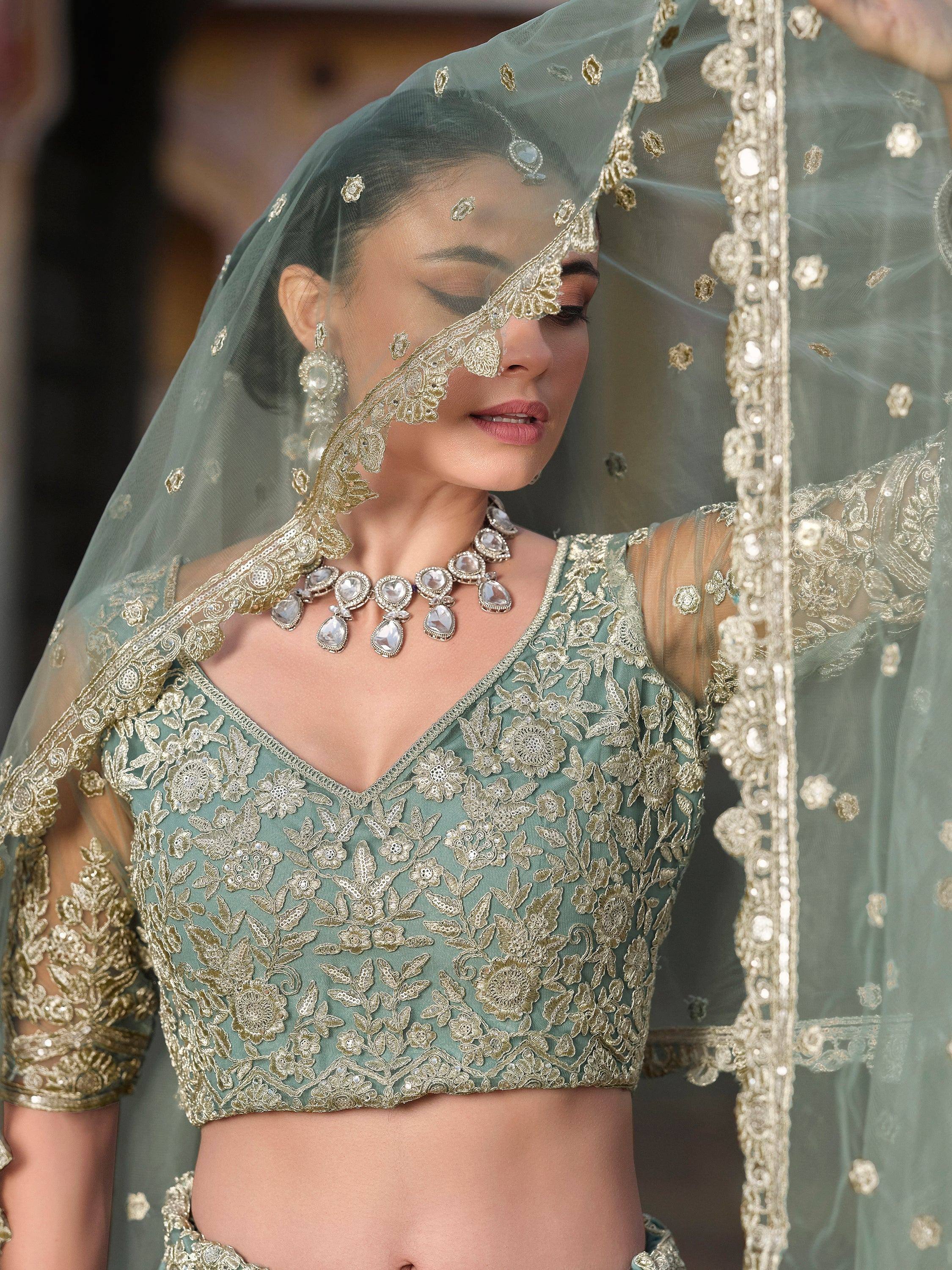 Elegant sage green lehenga choli with gold floral embroidery and matching dupatta for Indian weddings