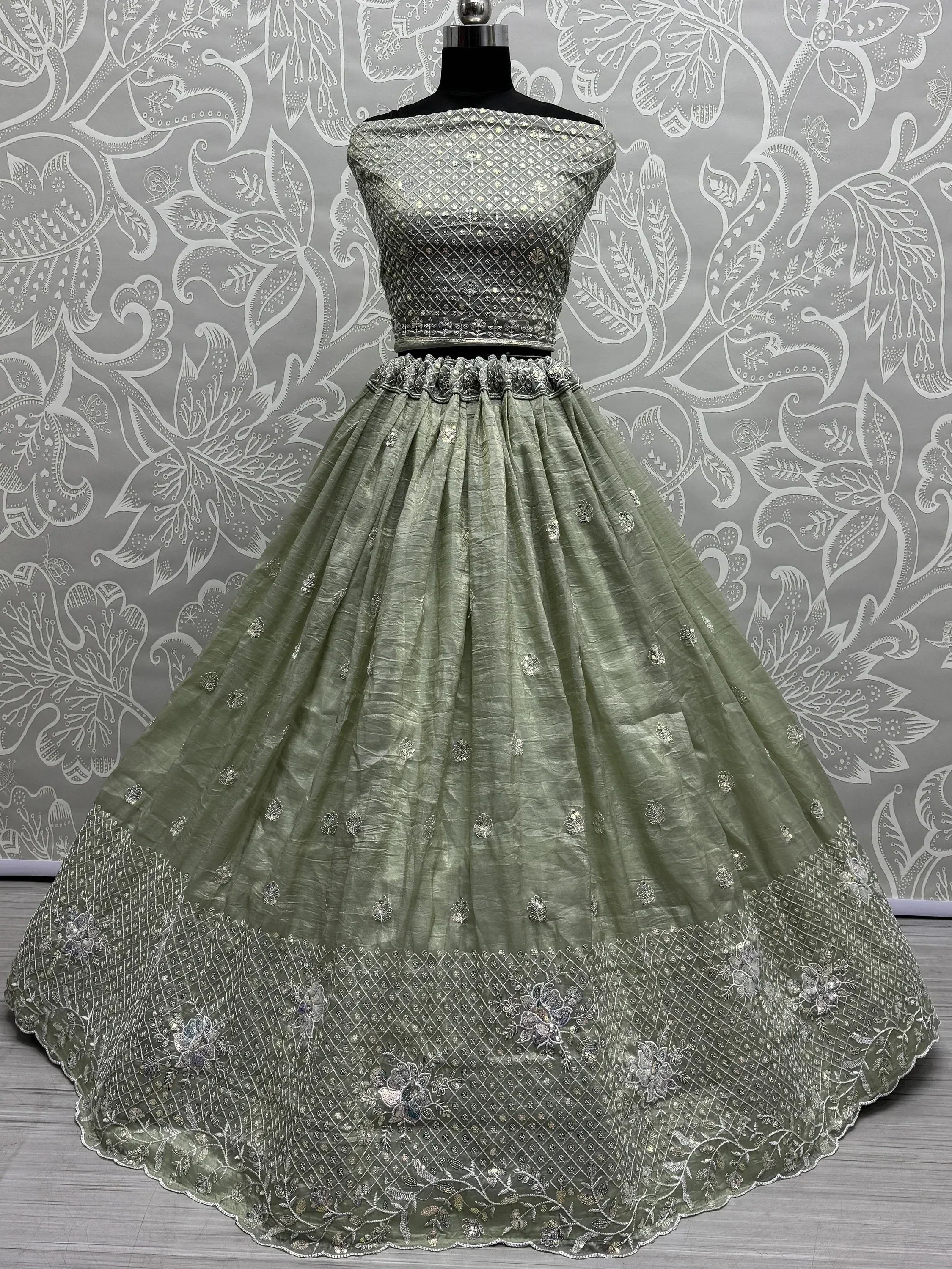 Olive green designer lehenga choli with silver embroidery, perfect for Indian ethnic wear occasions.