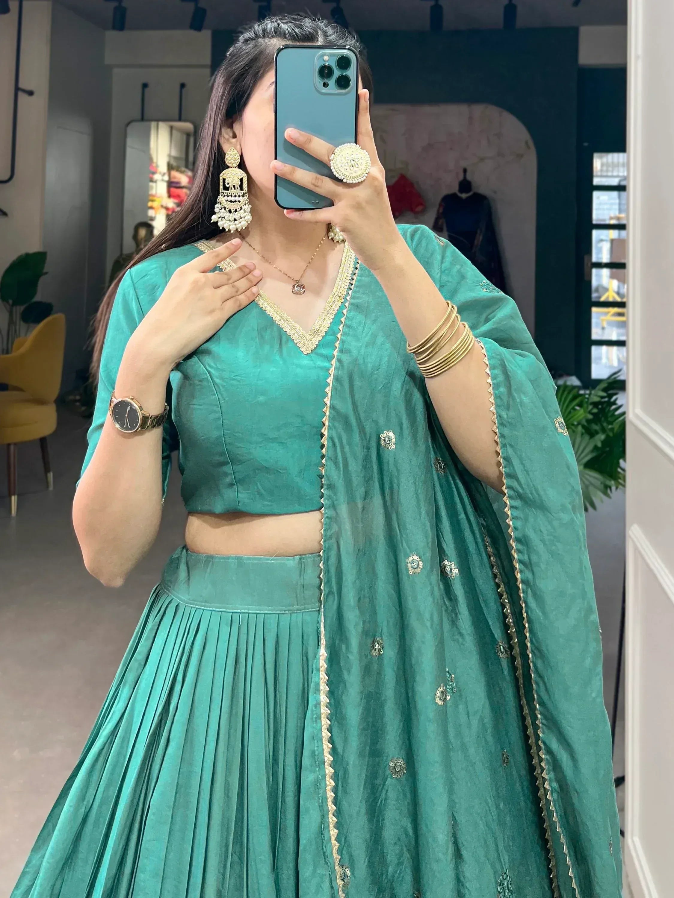 Teal green lehenga choli with gold embroidery, perfect for Indian ethnic wear and festive occasions.