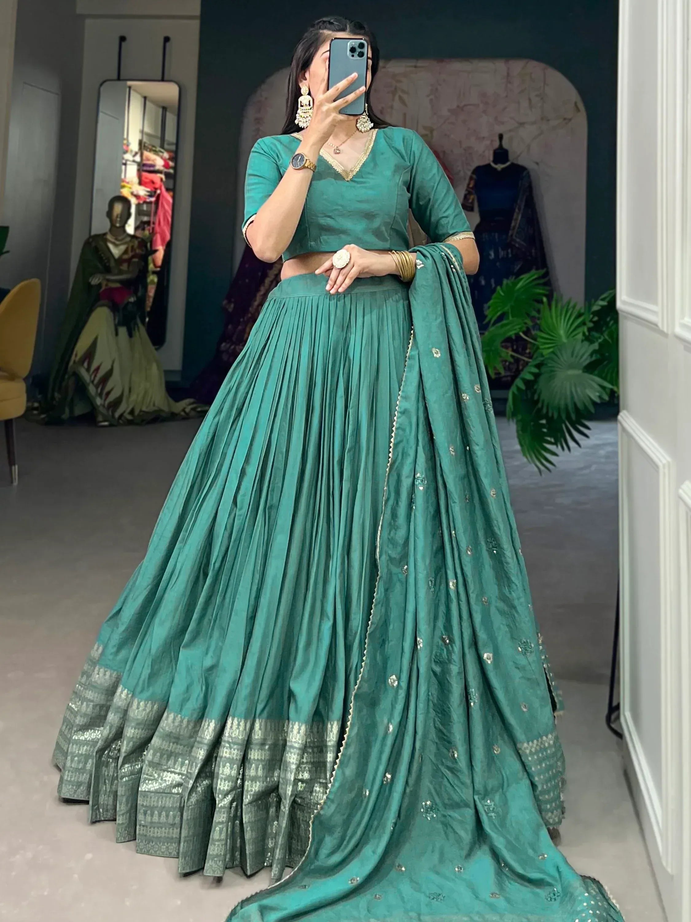 Teal green lehenga choli with gold embroidery, pleated skirt, and matching dupatta for Indian ethnic wear