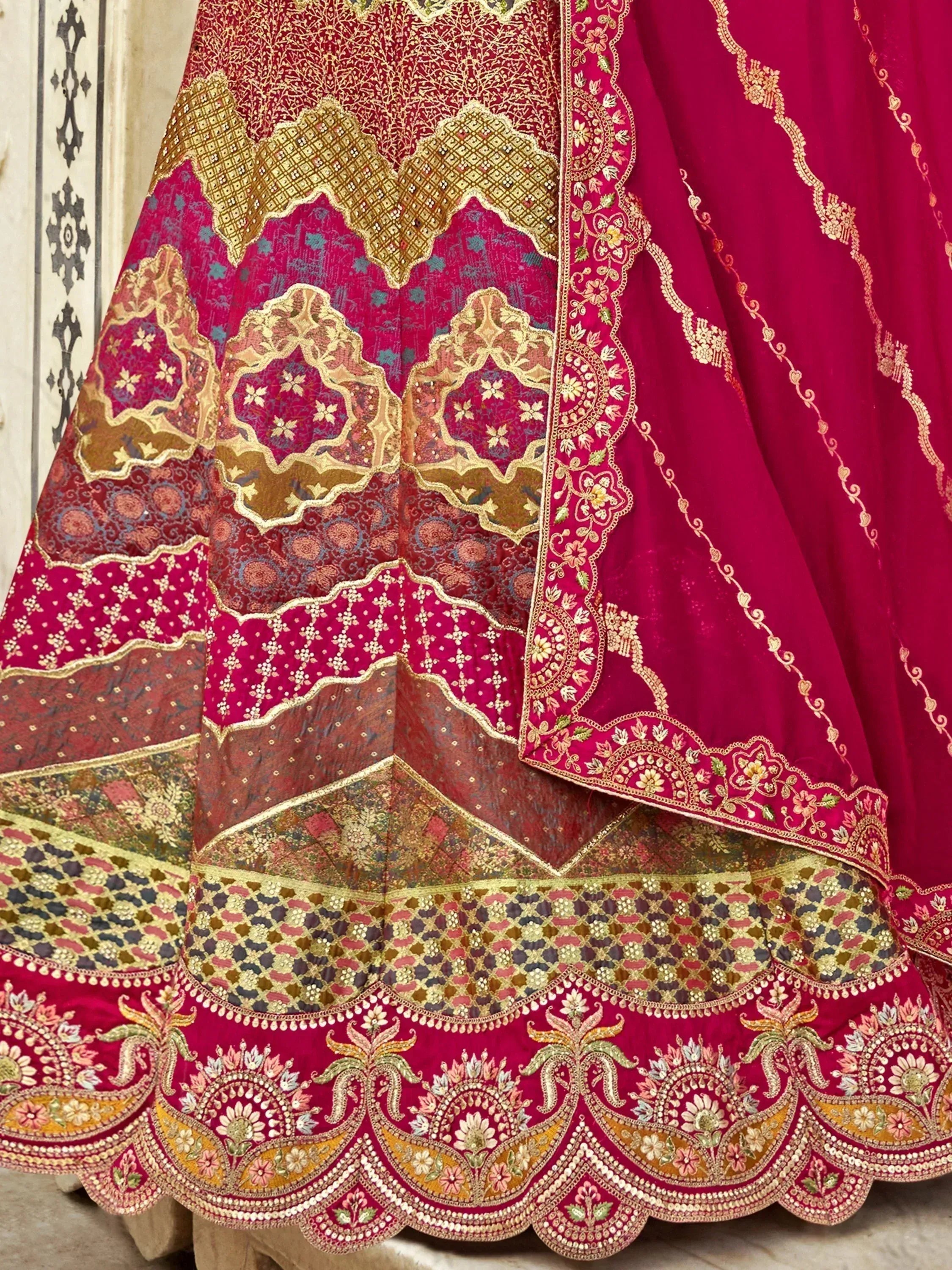Luxury red lehenga choli with intricate gold embroidery and floral motifs, perfect for Indian weddings and festive occasions.
