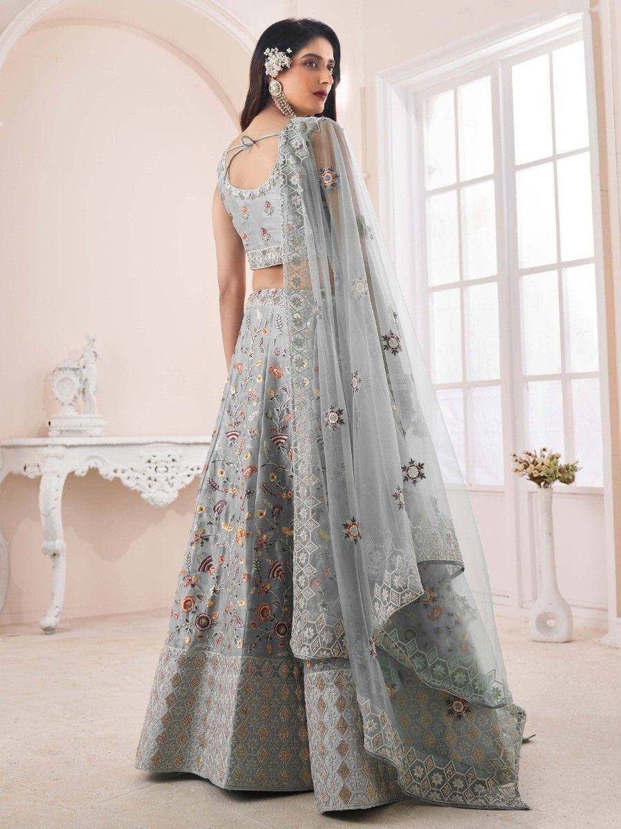 Elegant light blue embroidered lehenga choli with floral motifs and sheer dupatta, perfect for Indian ethnic occasions.
