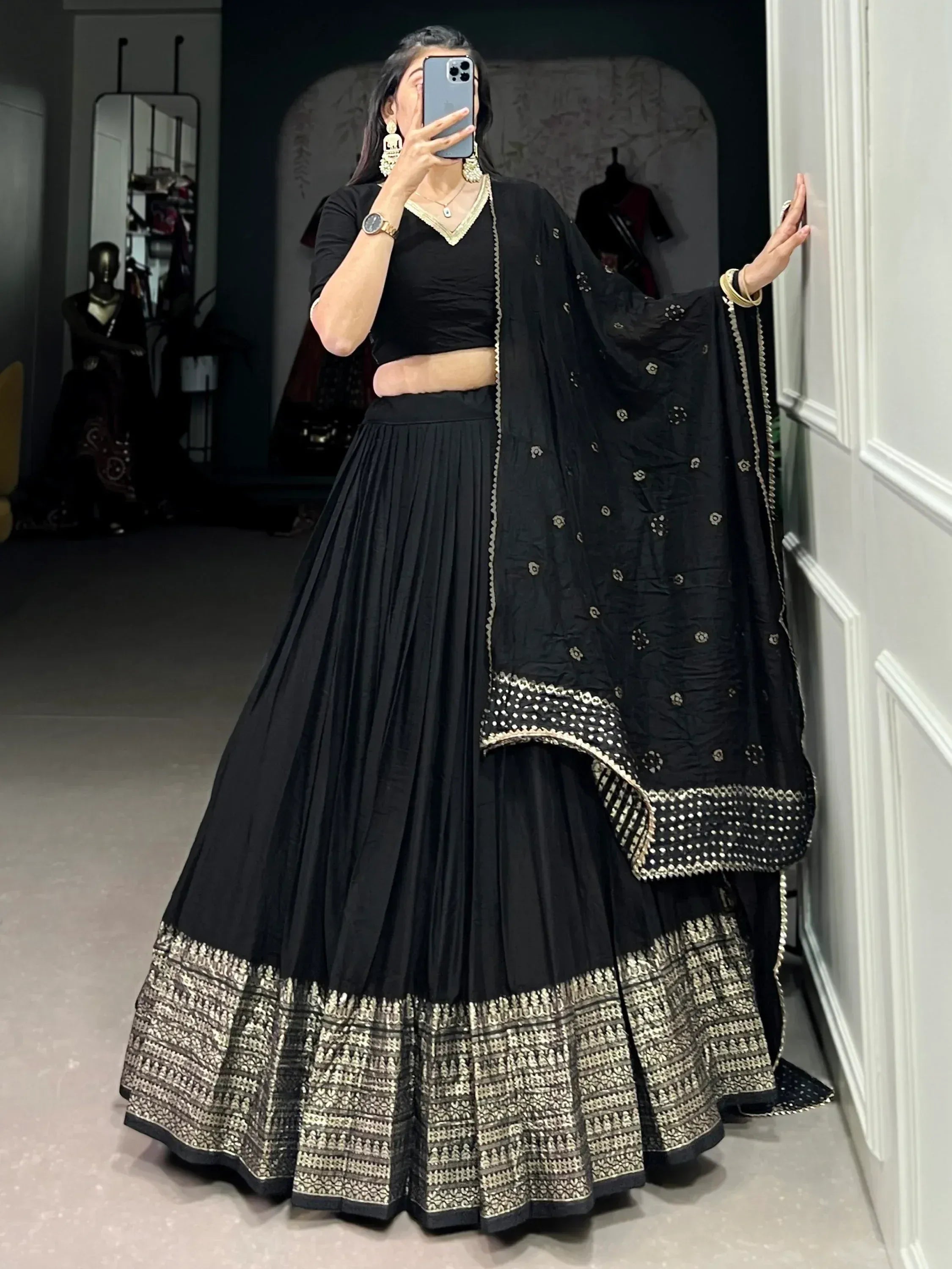 Black lehenga choli with gold embroidery and pleated skirt, ethnic Indian wear for women
