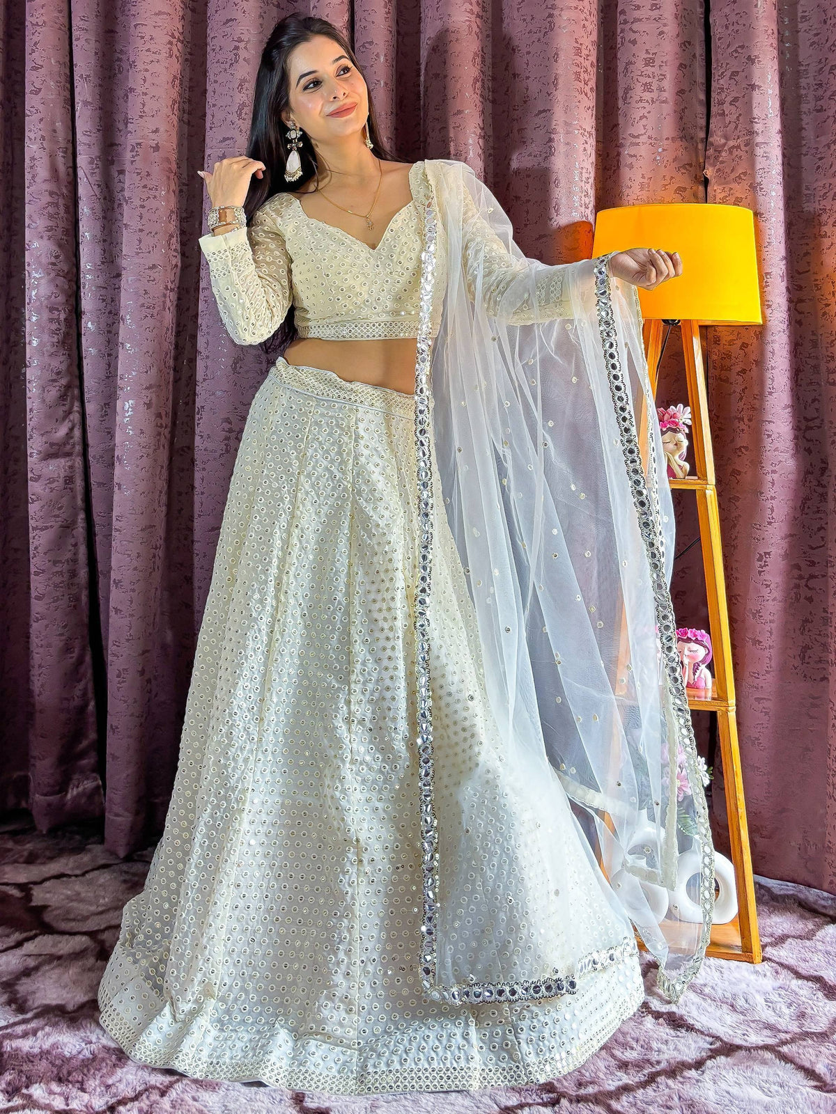 Elegant white mirror work lehenga choli with sheer dupatta, perfect for Indian ethnic wear and festive occasions.