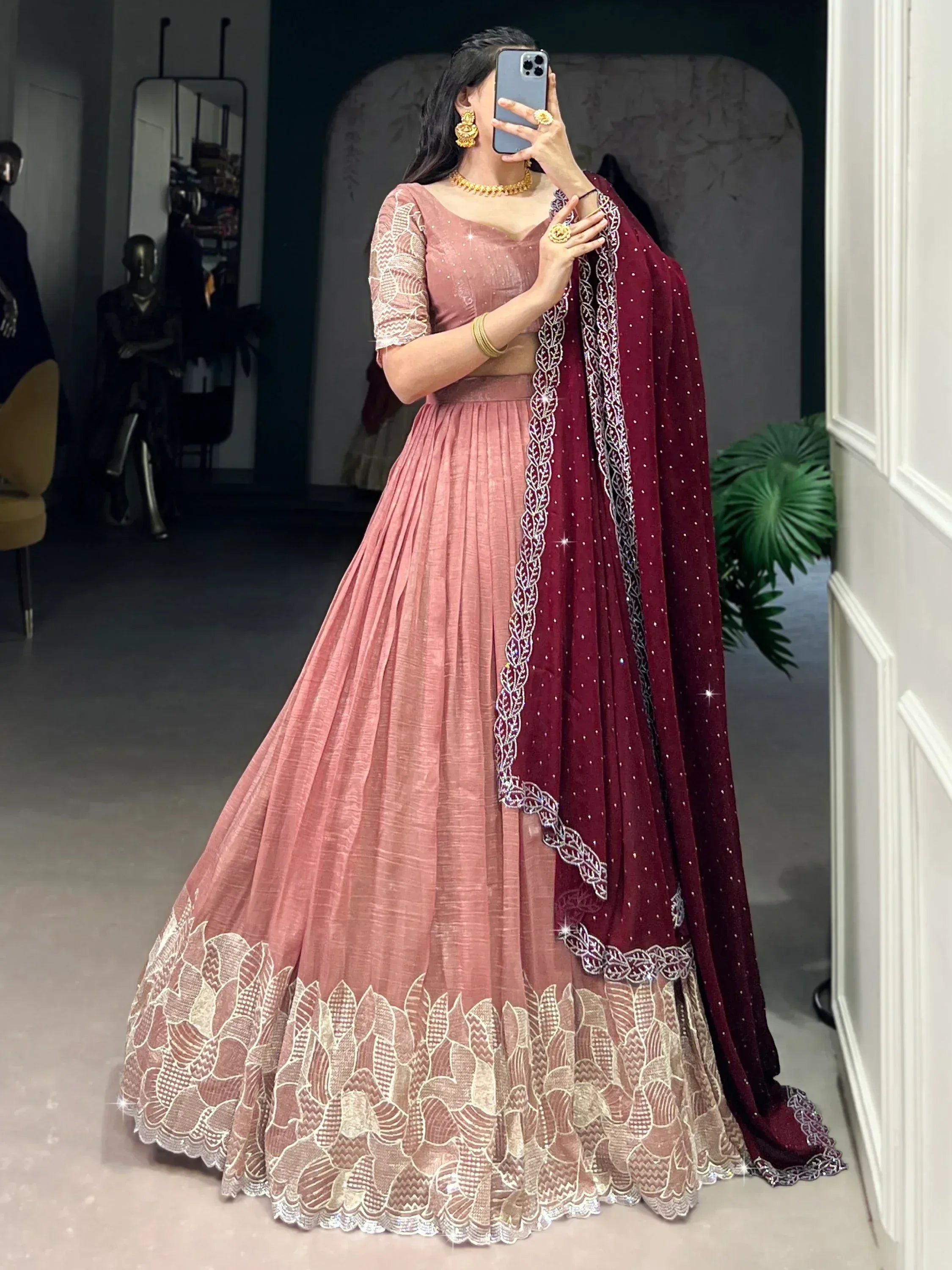 Dusty pink lehenga choli with gold embroidery and maroon dupatta, perfect for Indian ethnic wear events.