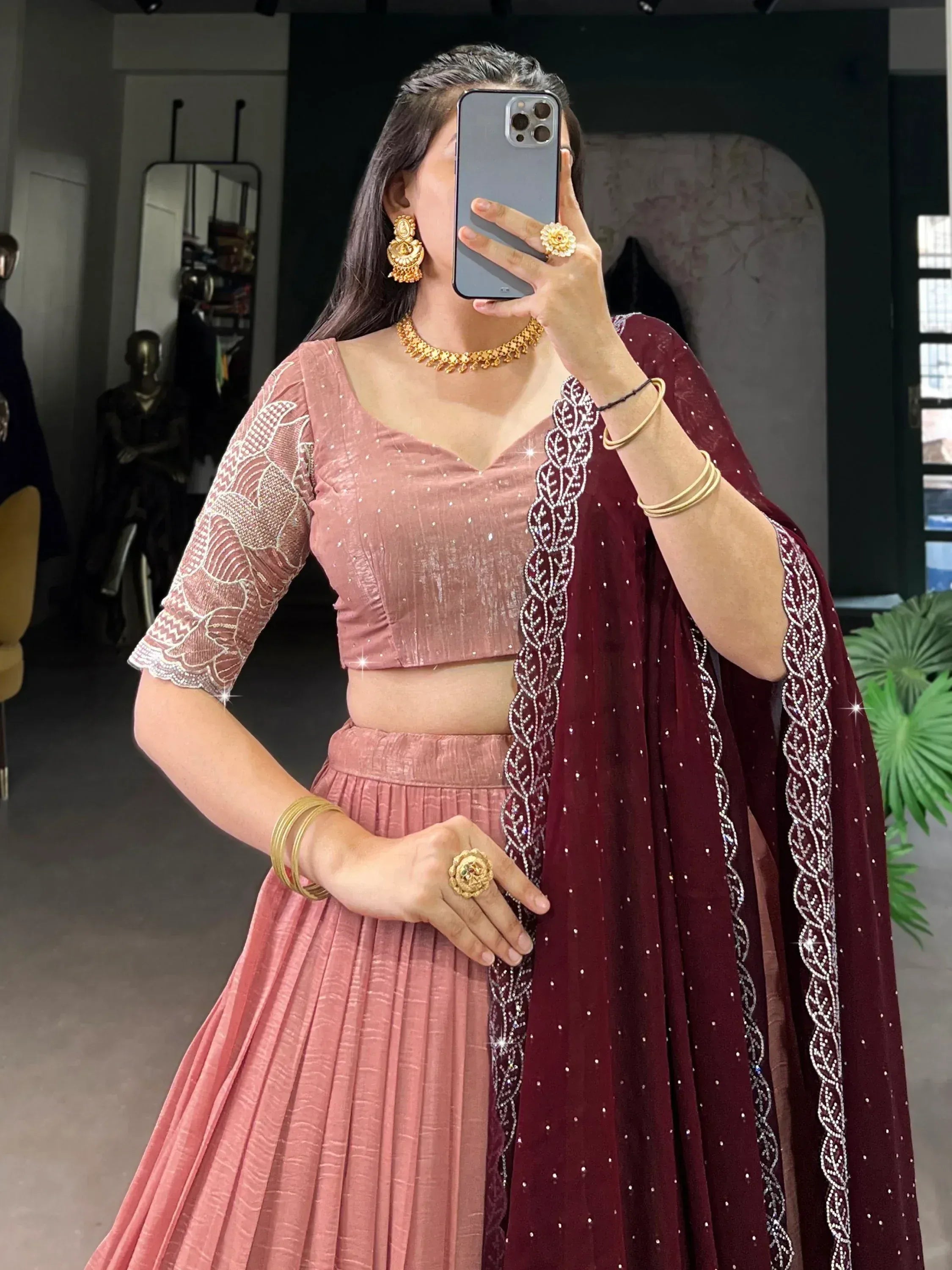 Pink velvet lehenga choli with maroon dupatta, embellished with sequins and embroidery, perfect for Indian ethnic occasions.