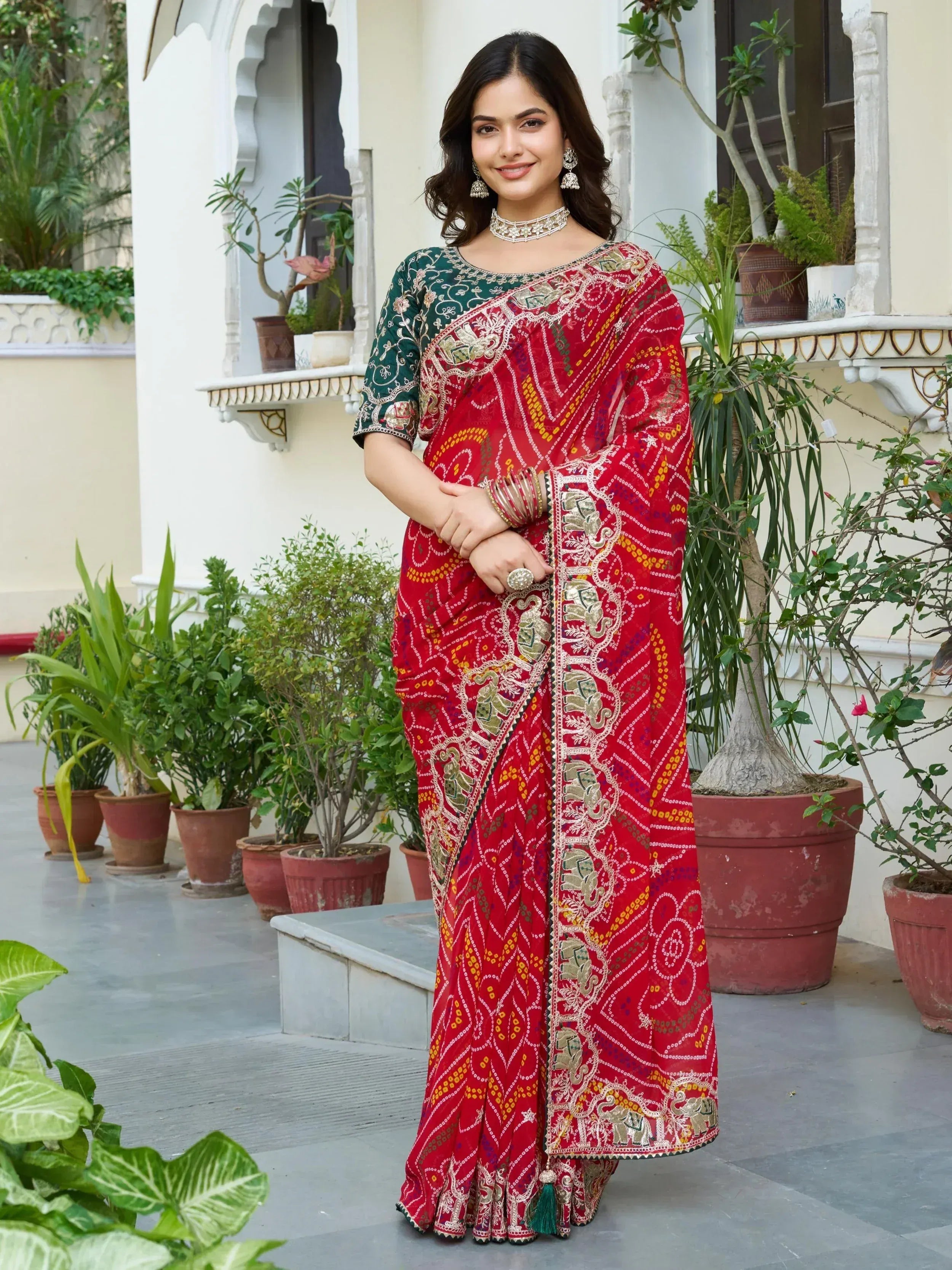 Red embroidered saree with elephant motifs, green blouse, traditional Indian ethnic wear for women