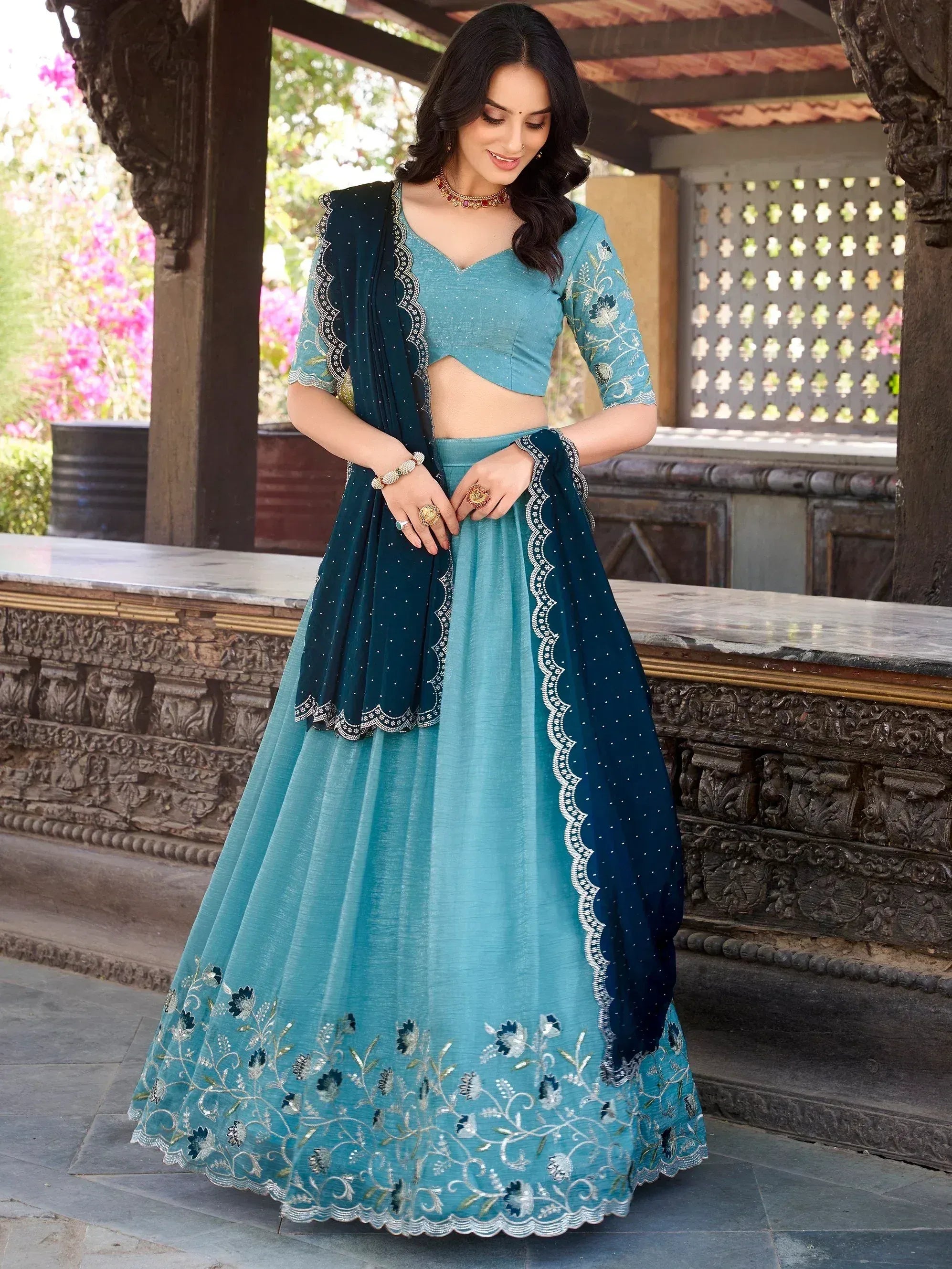 Teal embroidered lehenga choli with floral detailing and contrasting dupatta, perfect for Indian ethnic occasions
