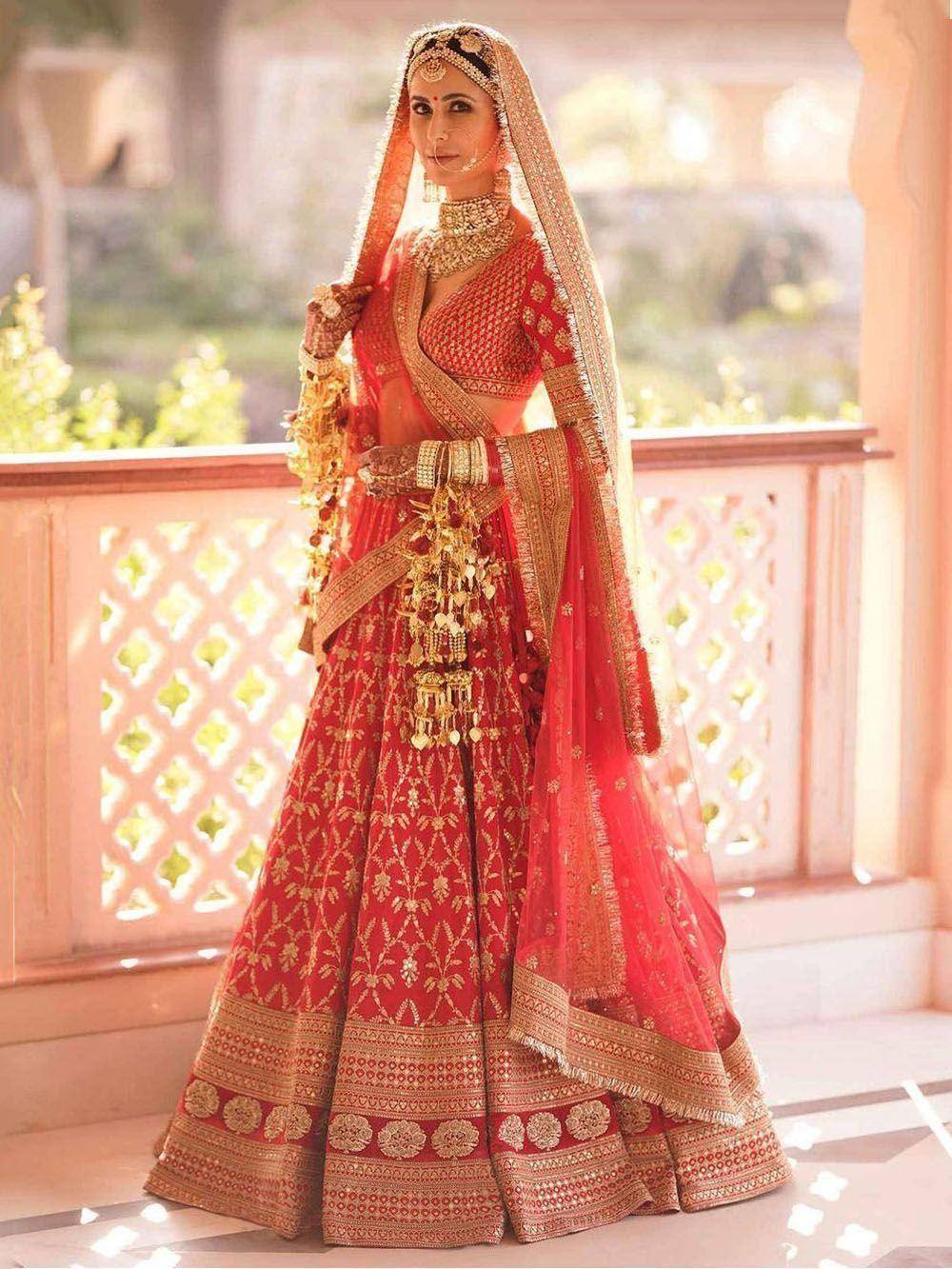 Red and gold bridal lehenga choli with intricate embroidery and matching dupatta for Indian weddings