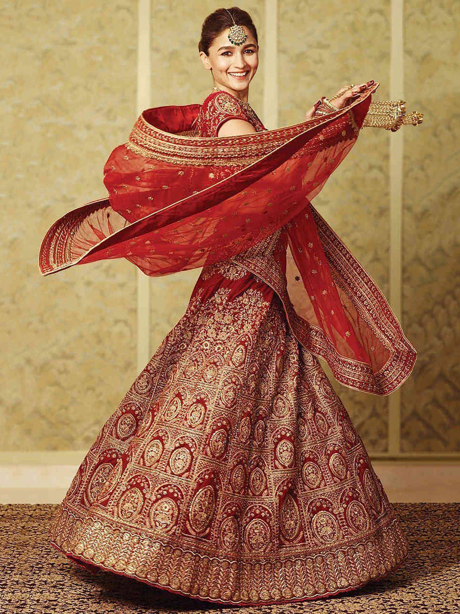 Red and gold embroidered lehenga choli with flowing dupatta, perfect for Indian weddings and festive occasions