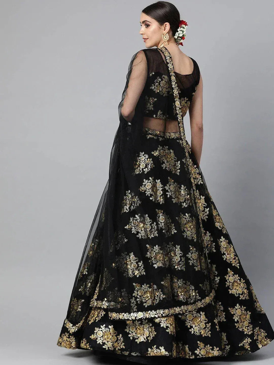 Black lehenga choli with gold floral embroidery, sheer dupatta, back view