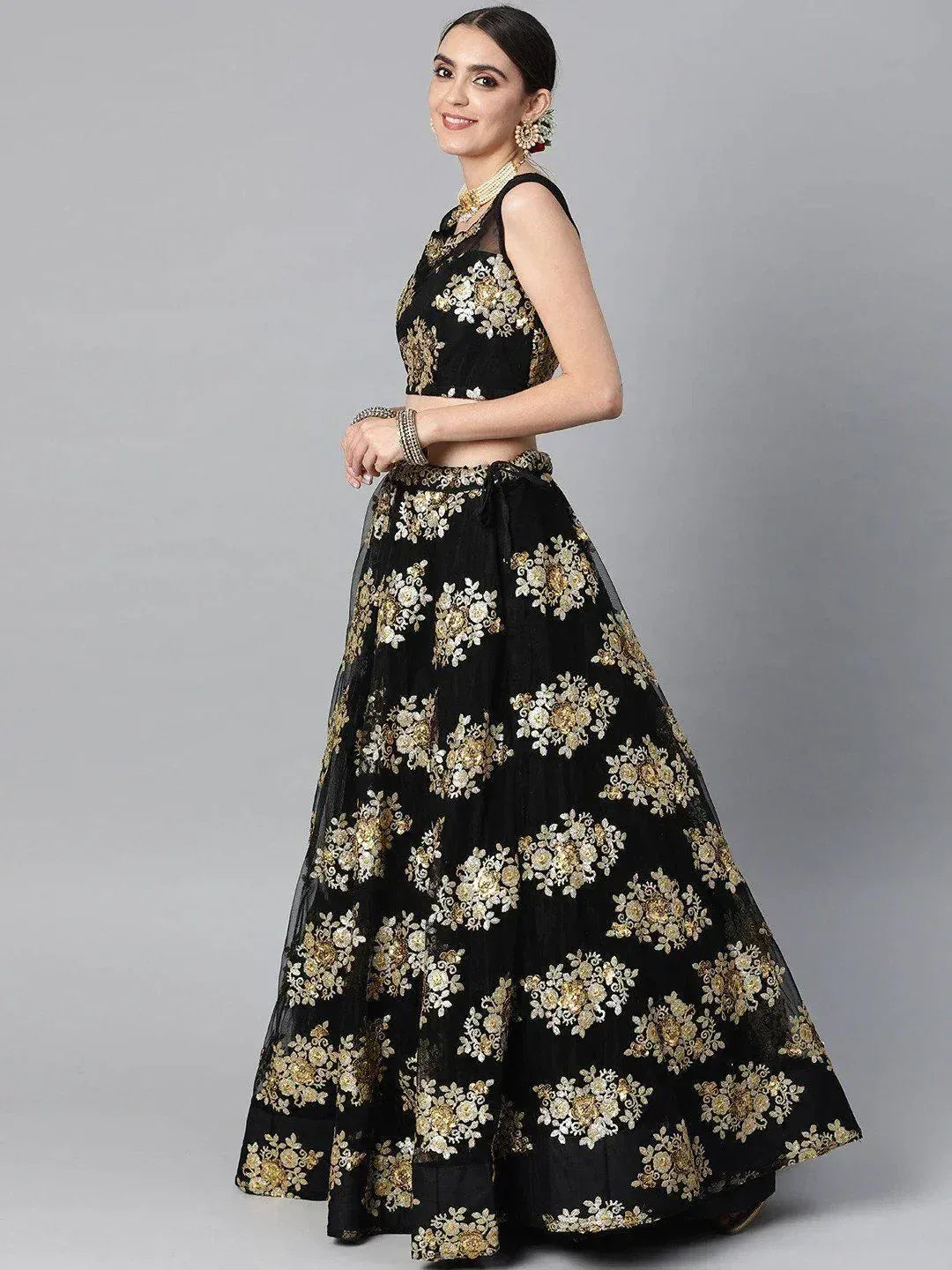 Black lehenga choli with gold floral embroidery, perfect for Indian ethnic wear and festive occasions.