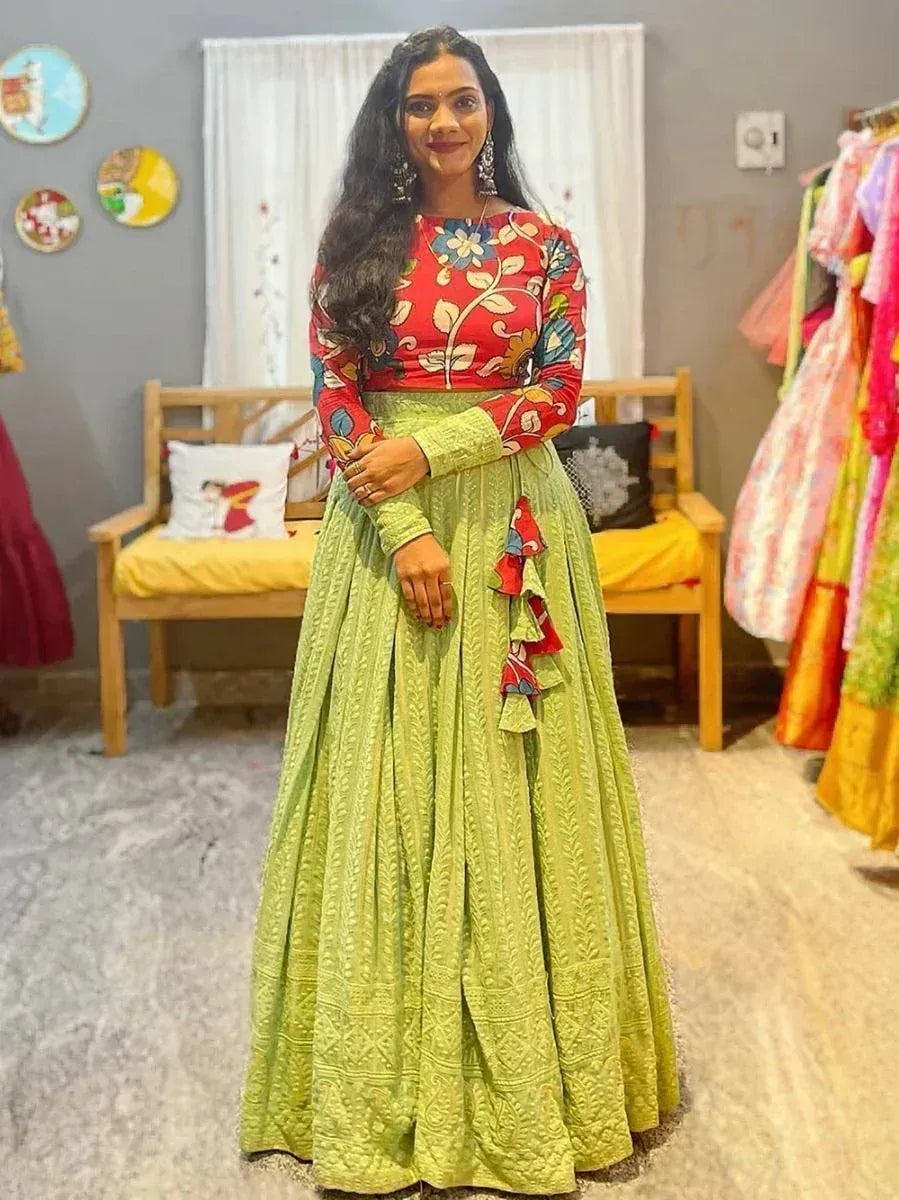 Woman in red floral top and green embroidered lehenga, Indian ethnic wear for festive occasions