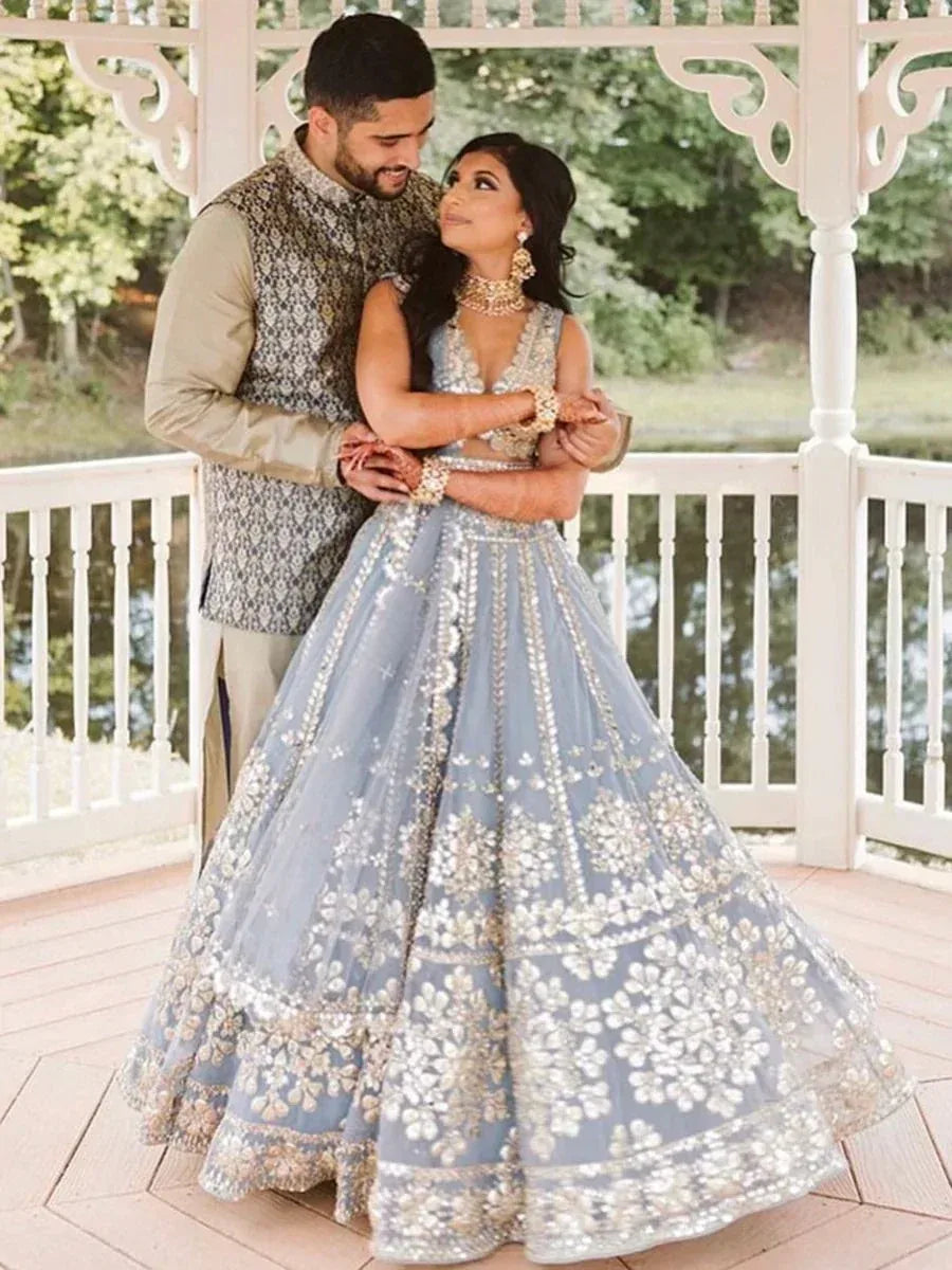 Elegant light blue lehenga choli with gold embroidery, perfect for Indian weddings and festive occasions.