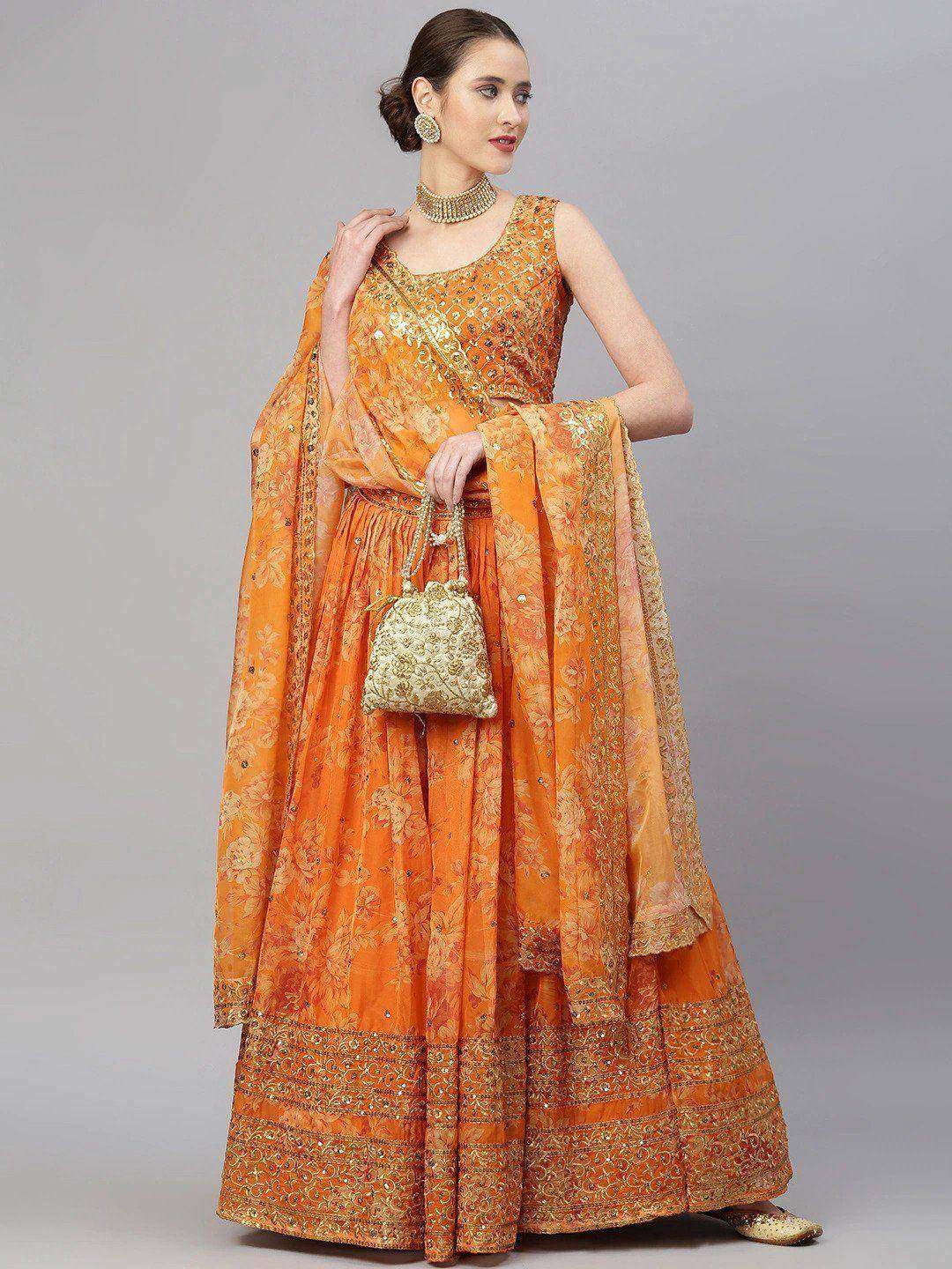 Orange floral embroidered lehenga choli with gold detailing and matching dupatta, perfect for Indian ethnic occasions