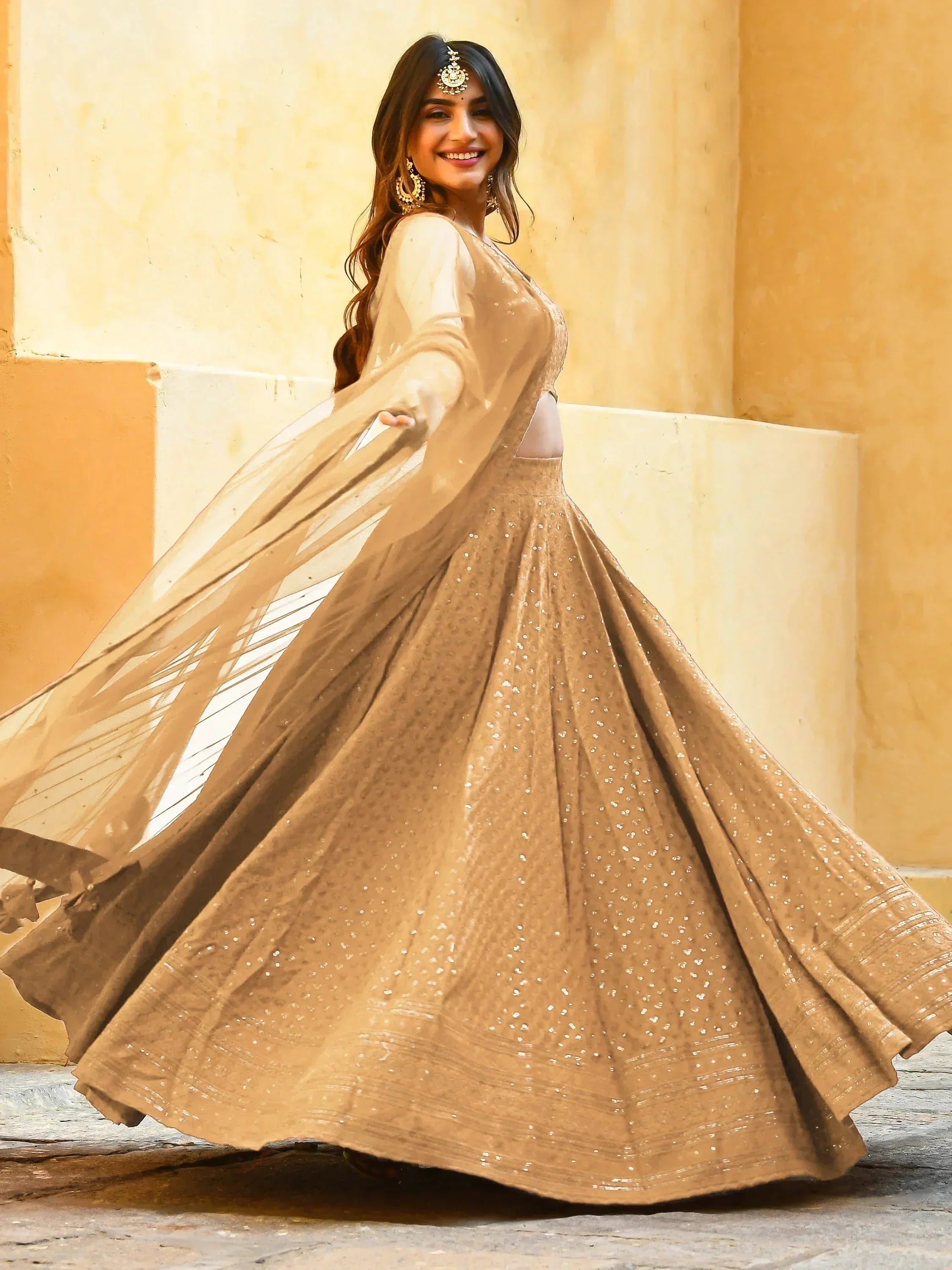 Elegant beige lehenga choli with sequins and sheer dupatta, perfect for Indian ethnic occasions