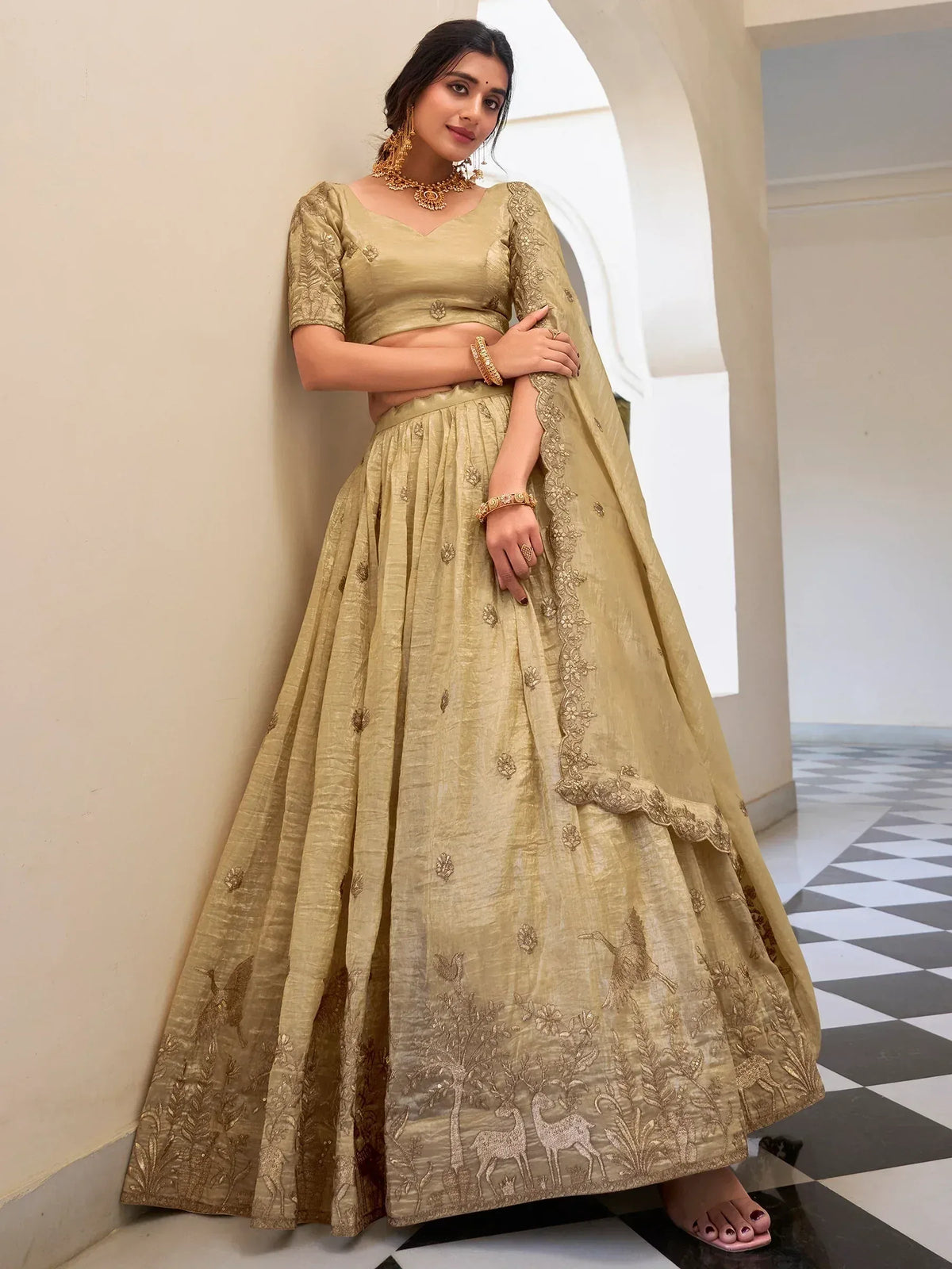 Elegant gold lehenga choli with deer and floral embroidery, perfect for Indian ethnic wear occasions.
