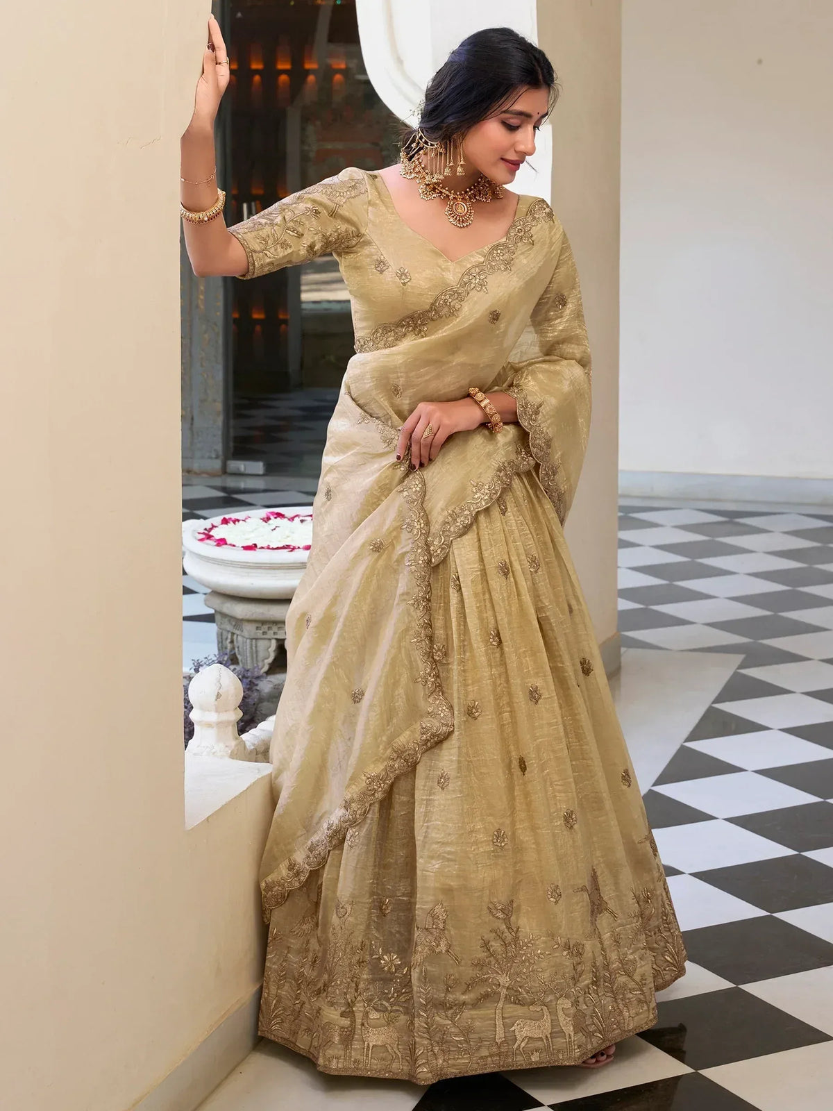 Elegant gold embroidered lehenga choli with deer motifs, perfect for Indian ethnic wear occasions