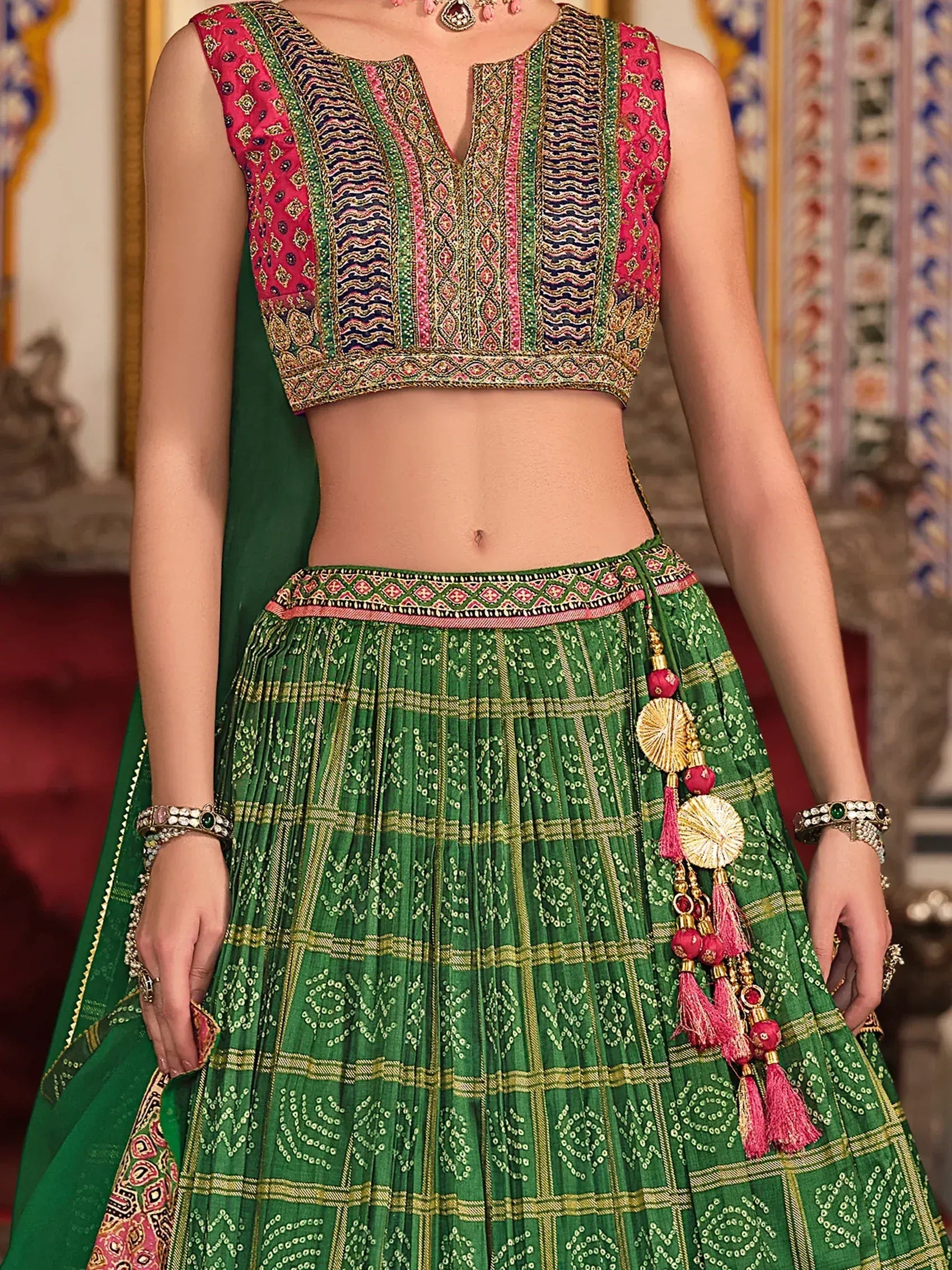 Green and pink embroidered lehenga choli with tassels, traditional Indian ethnic wear for women
