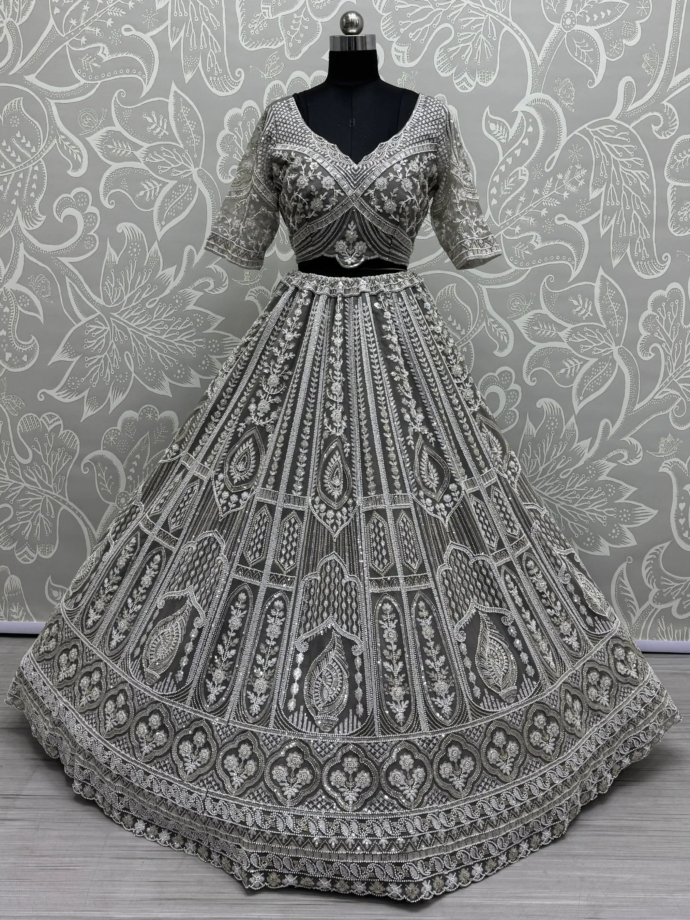 Grey designer lehenga choli with heavy silver embroidery and beadwork, perfect for weddings and festive occasions.