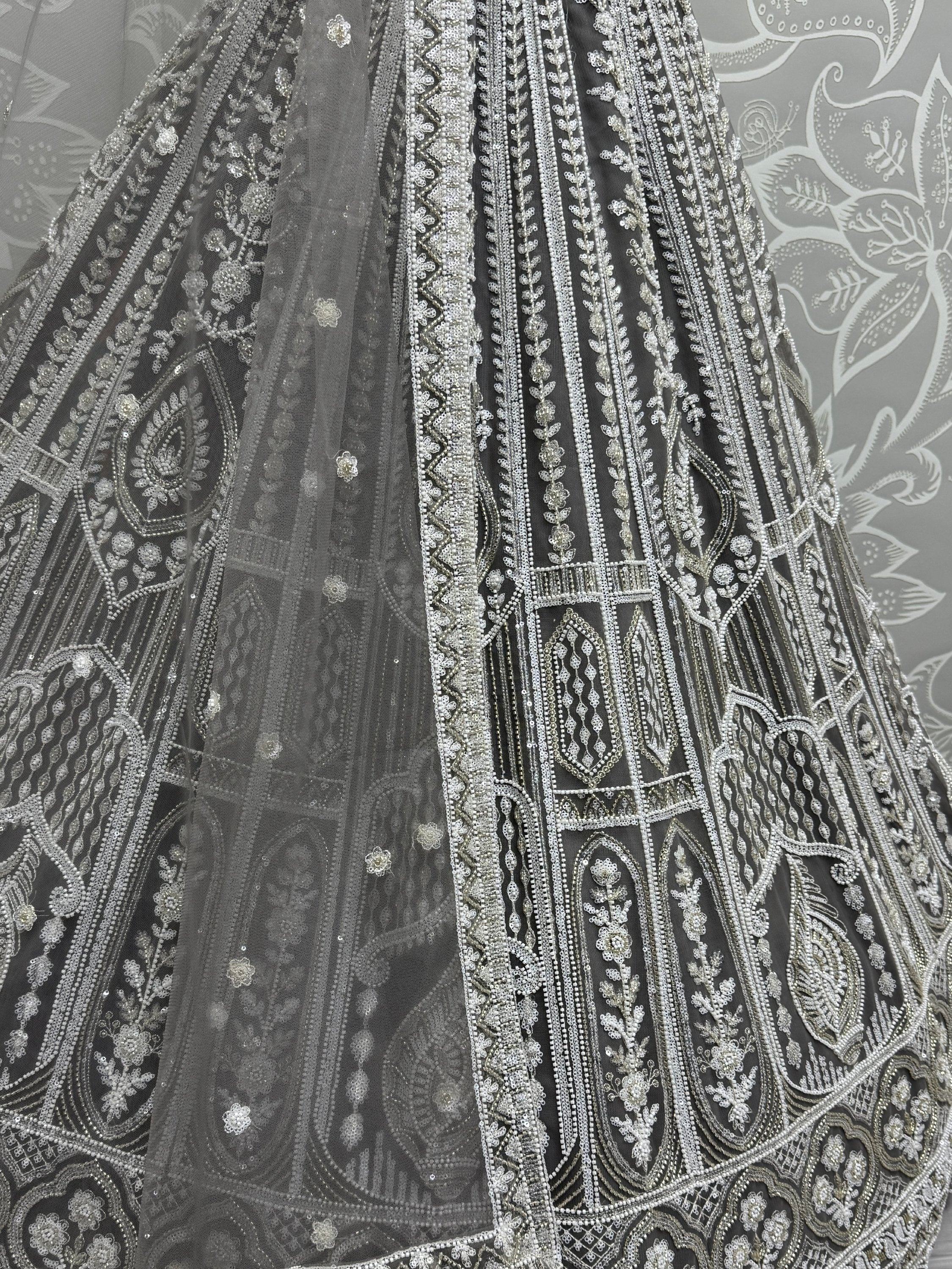 Grey designer lehenga with intricate silver embroidery and beadwork, perfect for Indian ethnic wear.