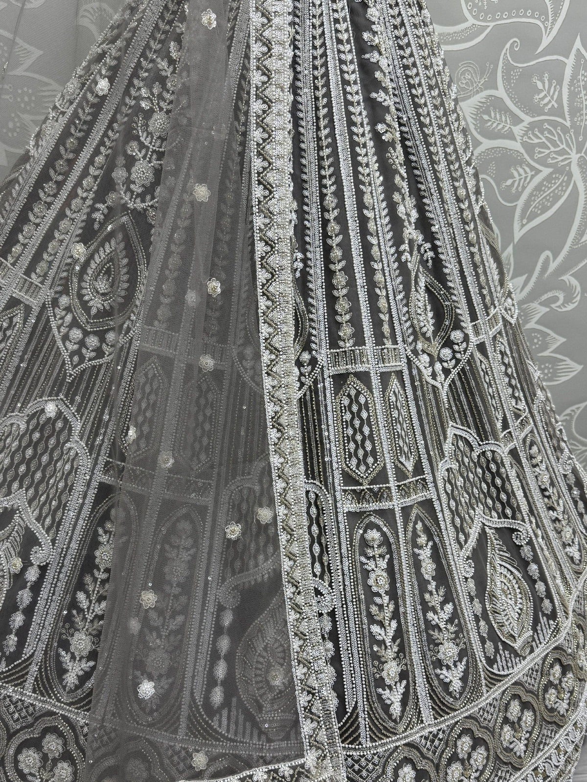 Grey designer lehenga with intricate silver embroidery and beadwork, perfect for Indian ethnic wear.