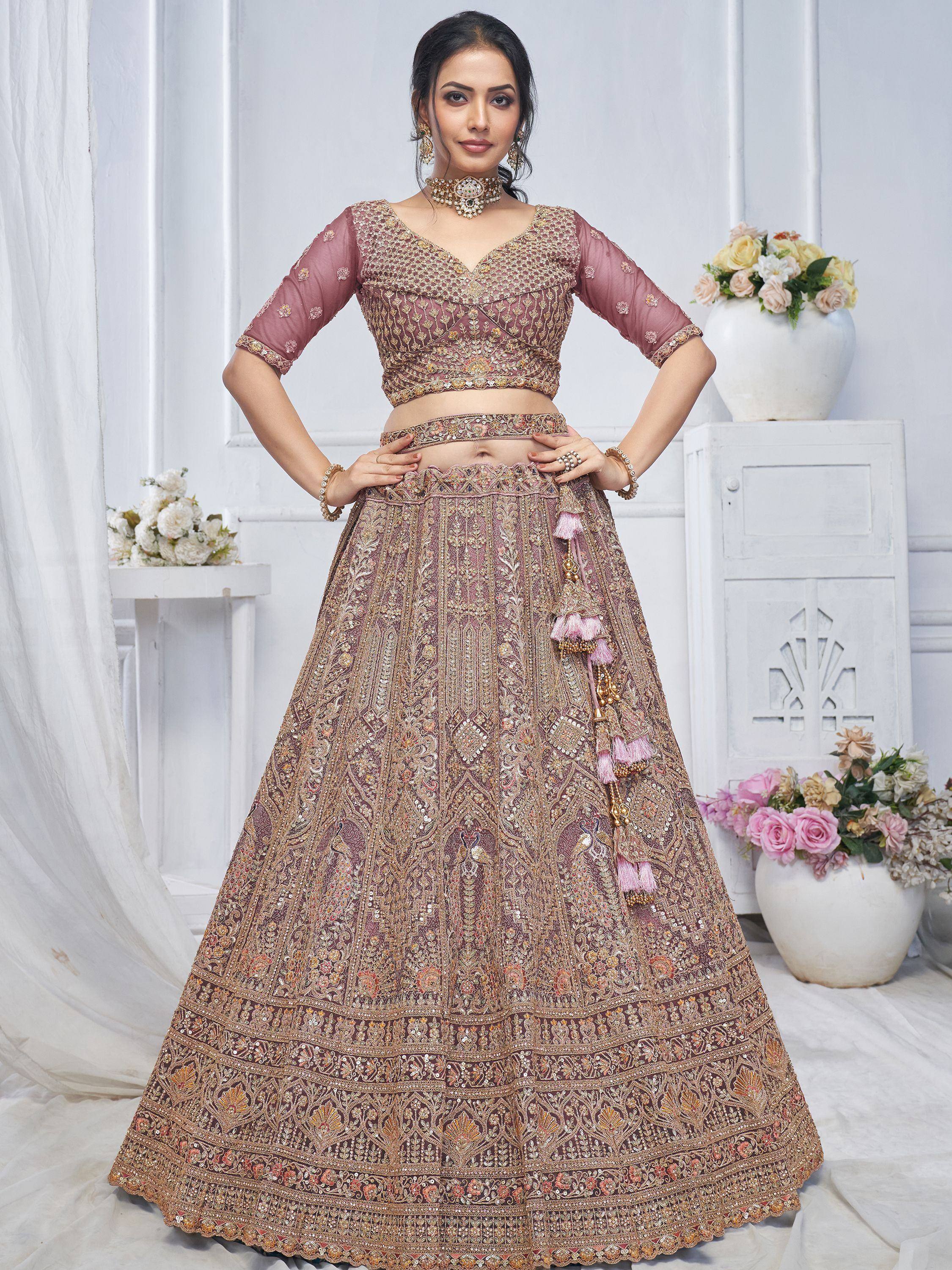 Elegant mauve lehenga choli with heavy gold embroidery and tassels, perfect for Indian weddings and festive occasions.