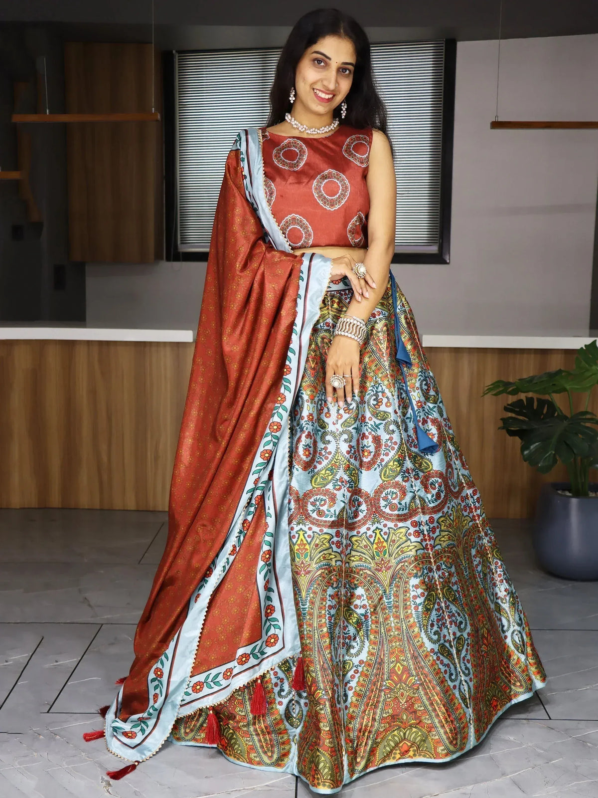 Woman in vibrant Indian lehenga choli with paisley print, perfect for ethnic occasions and festive wear.