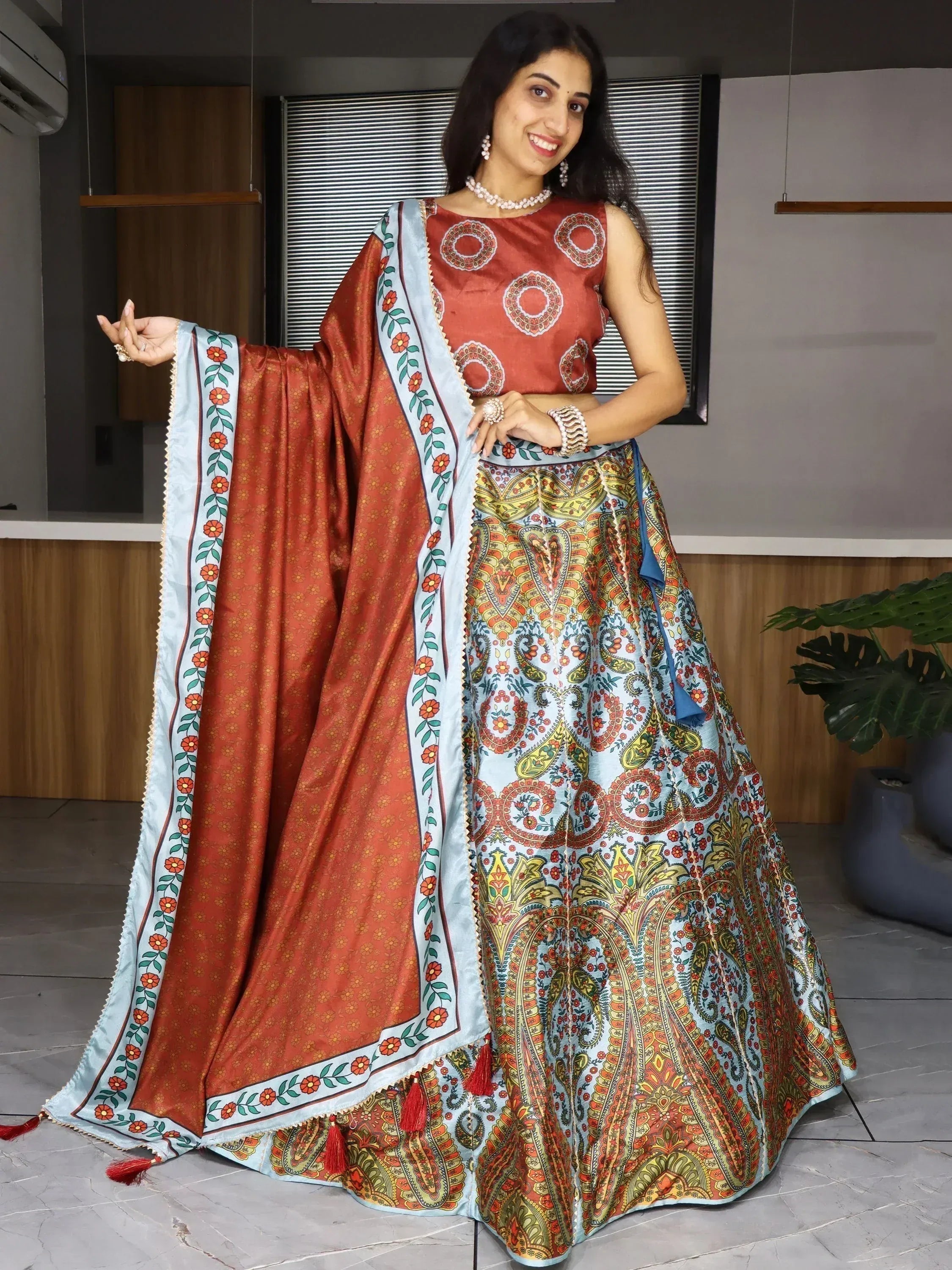 Woman in vibrant Indian lehenga choli with floral dupatta, perfect for ethnic occasions and festive wear.