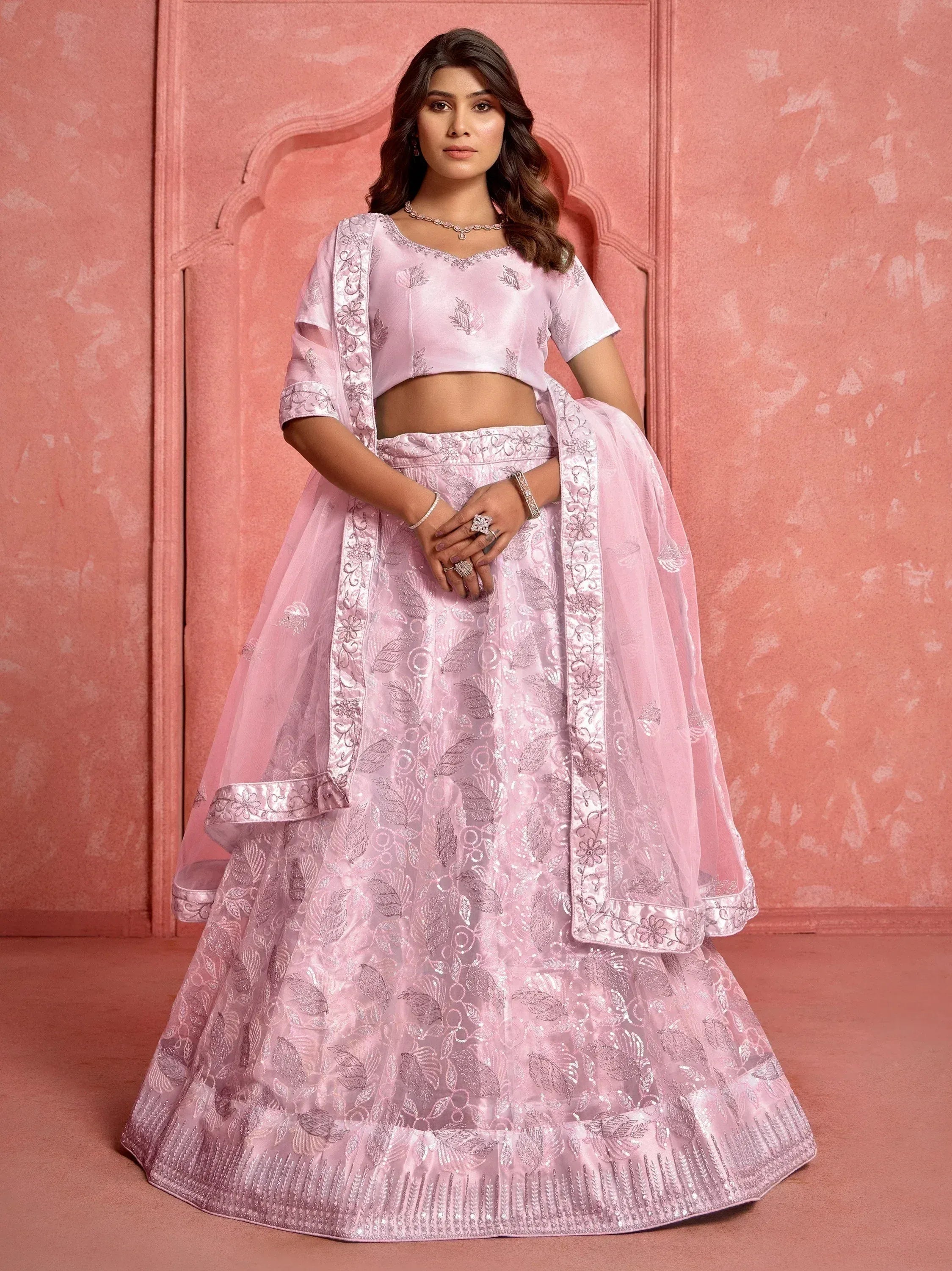 Pink embroidered lehenga choli with floral motifs, perfect for Indian ethnic wear occasions