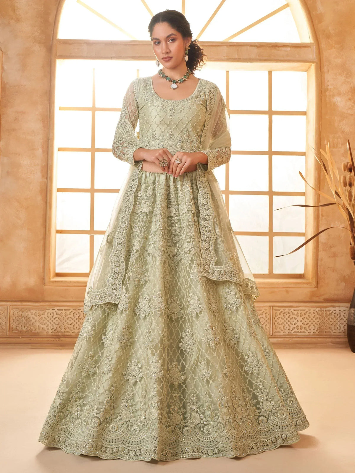 Elegant mint green embroidered lehenga choli with sheer dupatta, perfect for Indian weddings and festive occasions