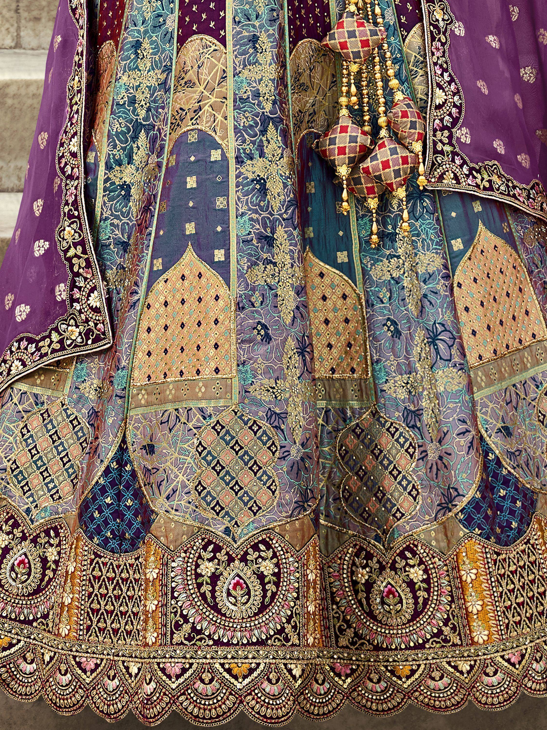 Luxury purple and teal lehenga choli with intricate gold embroidery and floral patterns, perfect for Indian weddings.