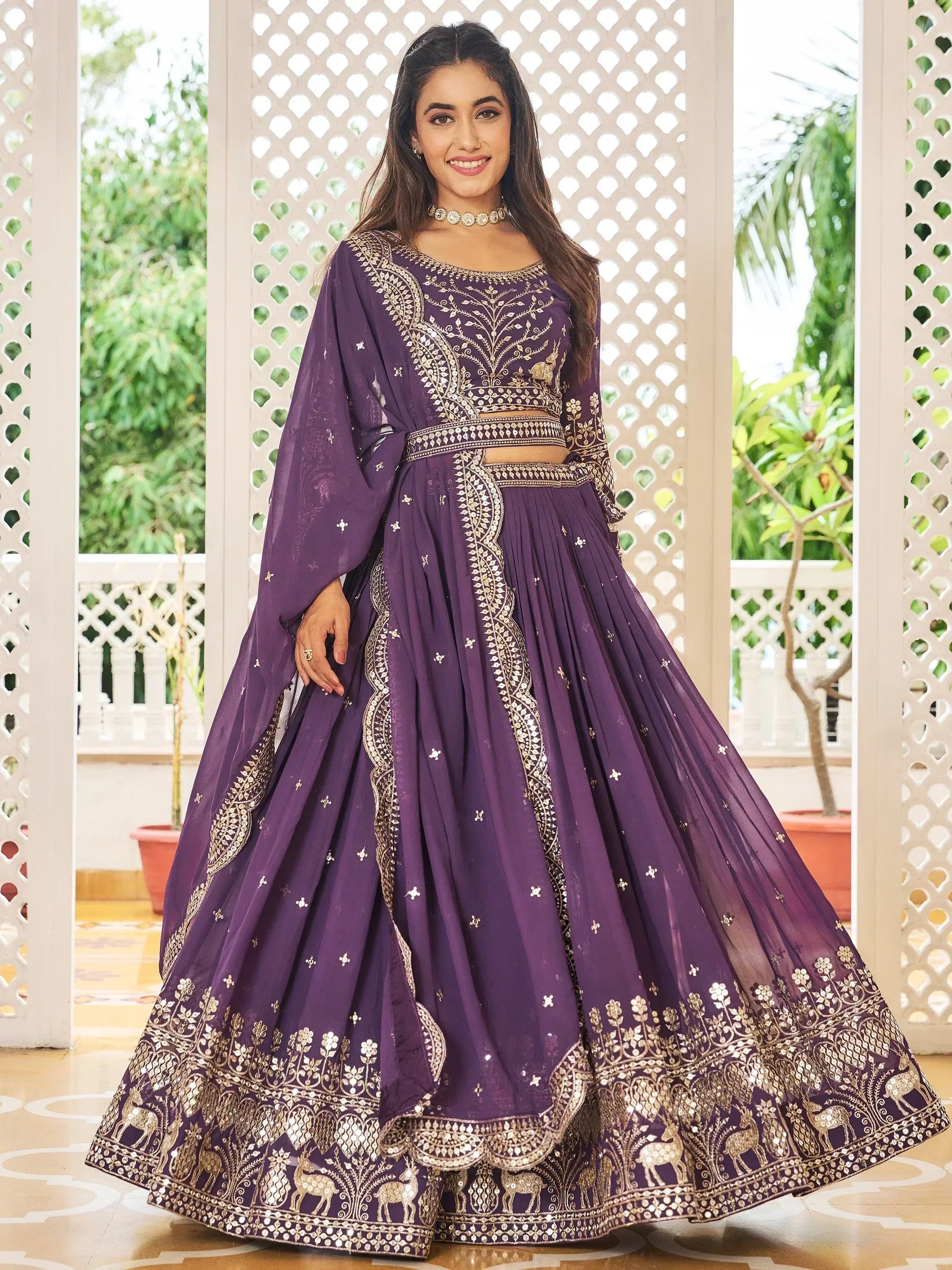 Purple designer lehenga choli with gold embroidery and mirror work, perfect for Indian ethnic wear occasions